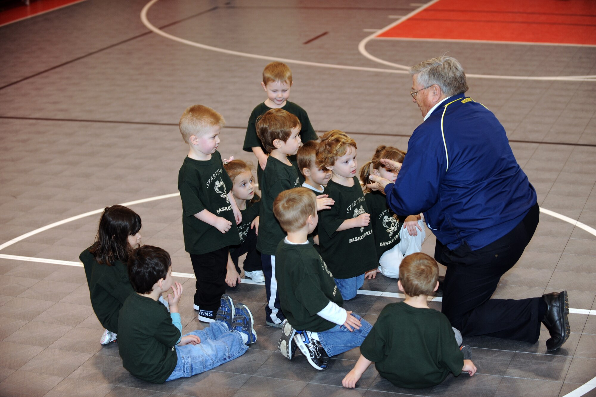 WHITEMAN AIR FORCE BASE, Mo. - Mike Orrison gathers the participants of the Start Smart youth sports program at the end of class Feb. 12, 2010. Mr. Orrison instructed the Start Smart class for parents and children ages 3-to 5 years-old. The program provides parents the opportunity to assist their child in learning sports fundamentals. (U.S. Air Force photo/Tech. Sgt. Charles Larkin Sr)