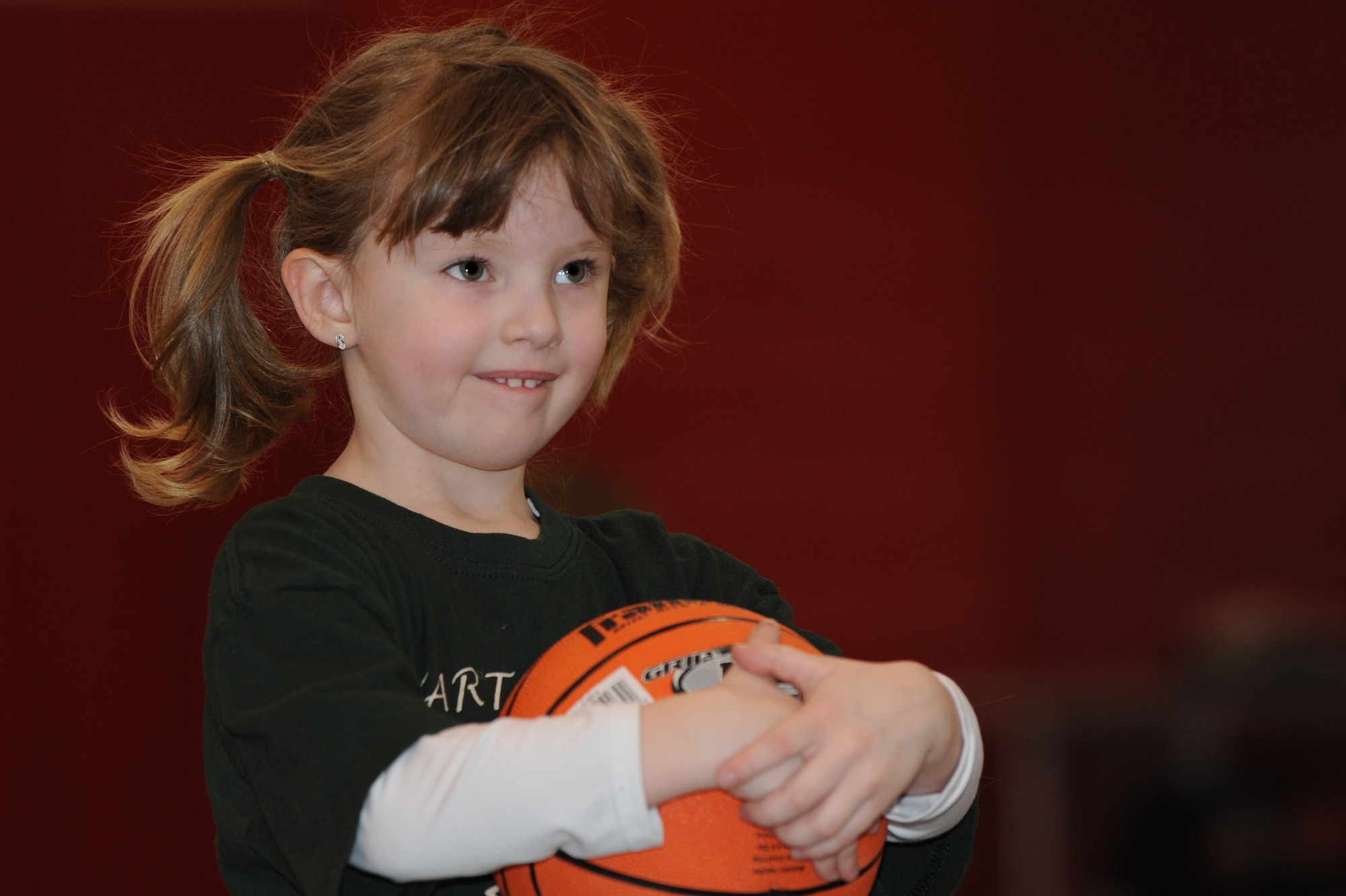 WHITEMAN AIR FORCE BASE, Mo. - Elizabeth Derheim awaits instructions during the Start Smart youth sports program Feb. 12, 2010.Whiteman Youth Center provides the Start Smart program to children ages 3-to 5-years-old. The children spent the hour learning basketball fundamentals and spending quality time with their parents. (U.S. Air Force photo/Tech. Sgt. Charles Larkin Sr)
