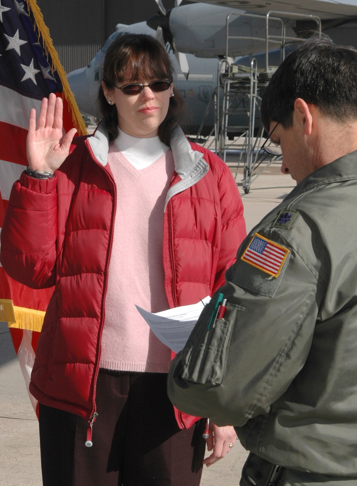 Raising her right hand, Deanna Leyba (left) is sworn in as a second lieutenant into the Air Force Reserve Feb. 12 at Peterson Air Force Base, Colo. Ms. Leyba, accepting the oath from Lt. Col. Frank Dearden, was sworn in as an officer assigned to the 302nd Airlift Wing and will be a flight nurse within the 34th Aeromedical Evacuation Squadron. (U.S. Air Force photo/Staff Sgt. Stephen J. Collier)