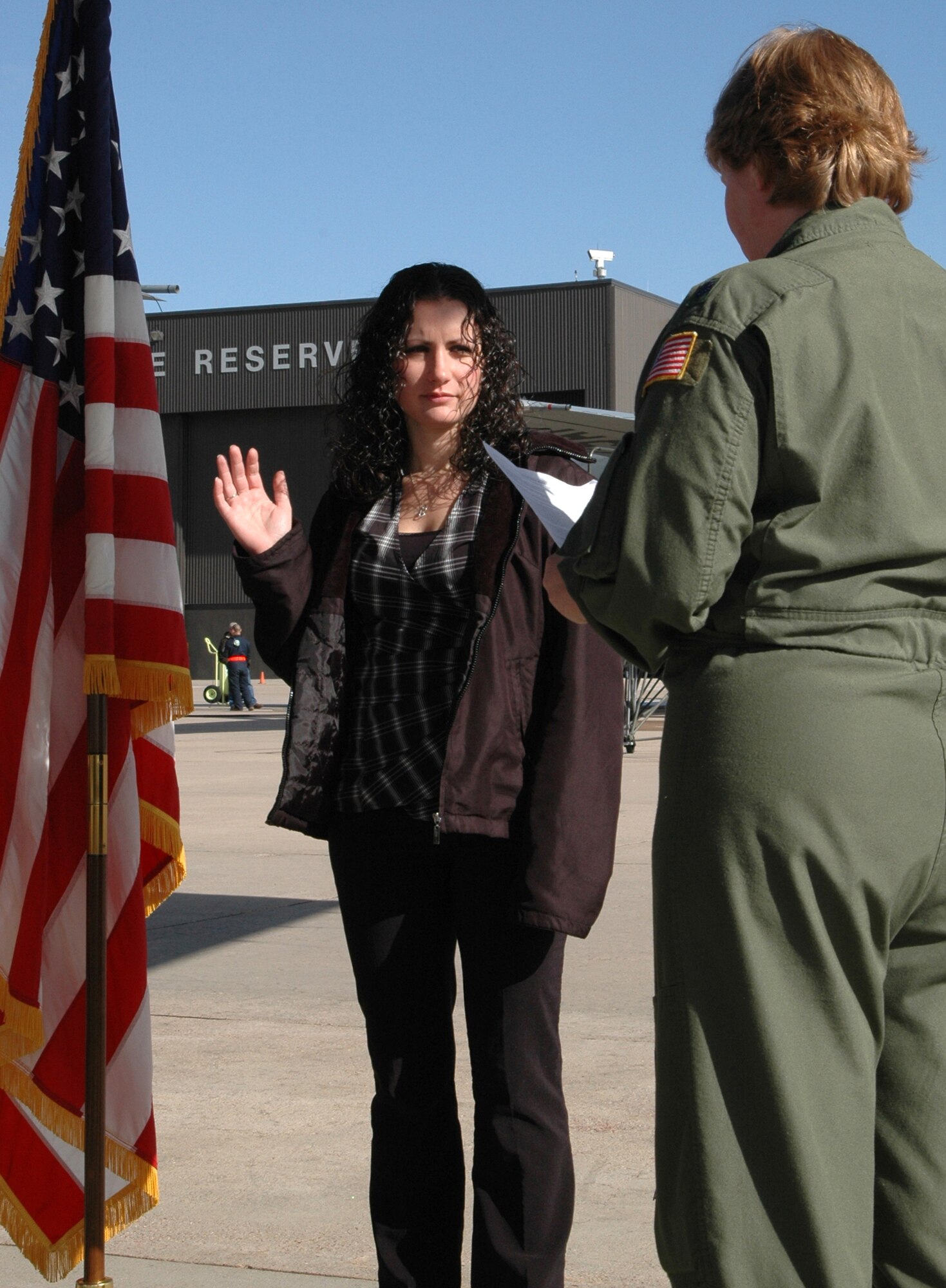 With her right hand raised, Ann Barnes (left) is sworn in as a second lieutenant into the Air Force Reserve Feb. 12 at Peterson Air Force Base, Colo. Ms. Barnes, accepting the oath from Lt. Col. Lieselotte Kennedy, was sworn in as an officer assigned to the 302nd Airlift Wing and will be a flight nurse within the 34th Aeromedical Evacuation Squadron. (U.S. Air Force photo/Staff Sgt. Stephen J. Collier)
