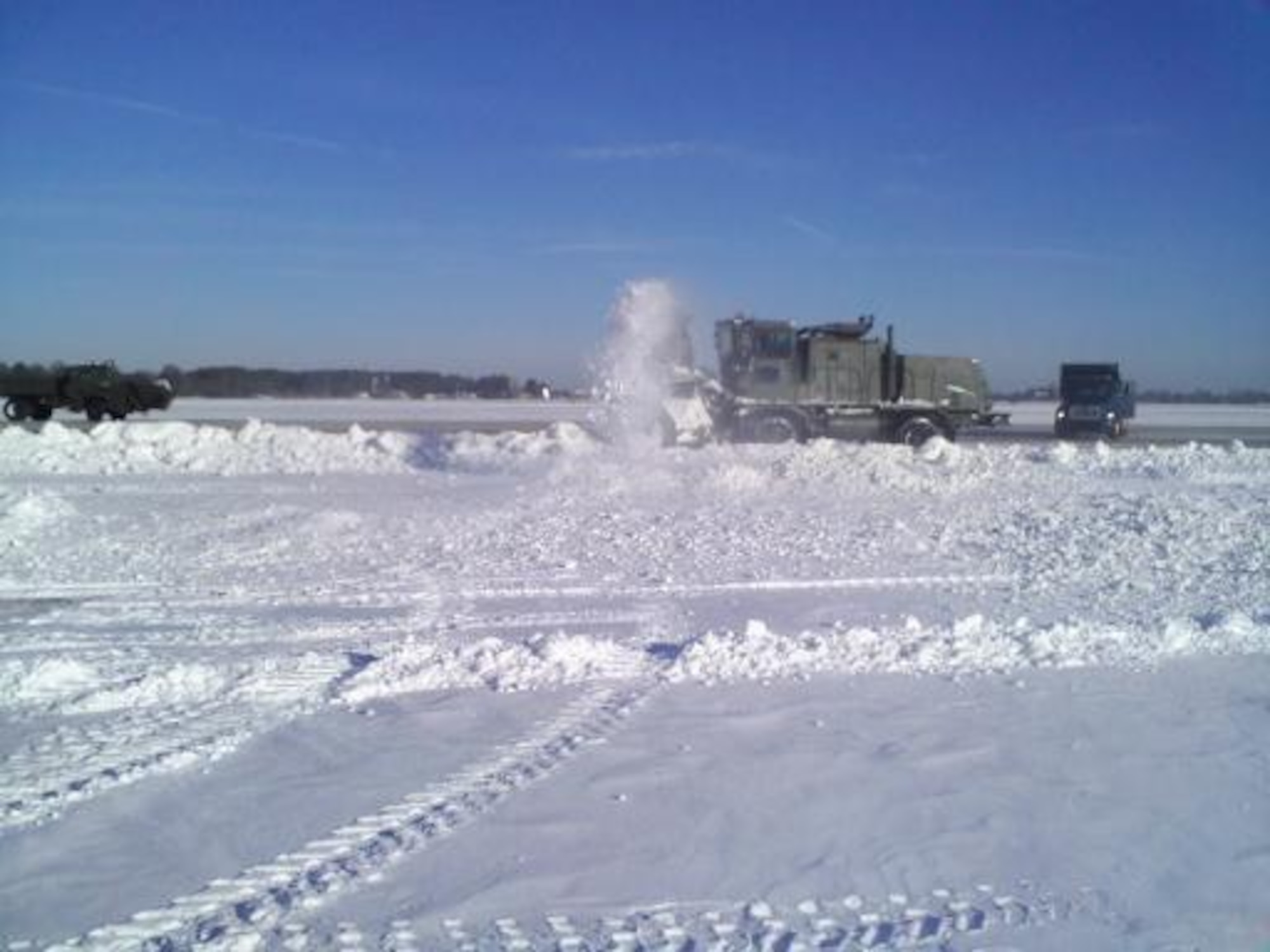 LANGLEY AIR FORCE BASE, Va. -- 633d Civil Engineer Squadron crews use heavy-duty plows to remove snow from the flight line Feb. 1. The teams cleared the initial snowfall from the airfield within 24 hours, ensuring critical homeland security and humanitarian missions were uninterrupted. (Photo courtesy Tech. Sgt. Robert Shay)