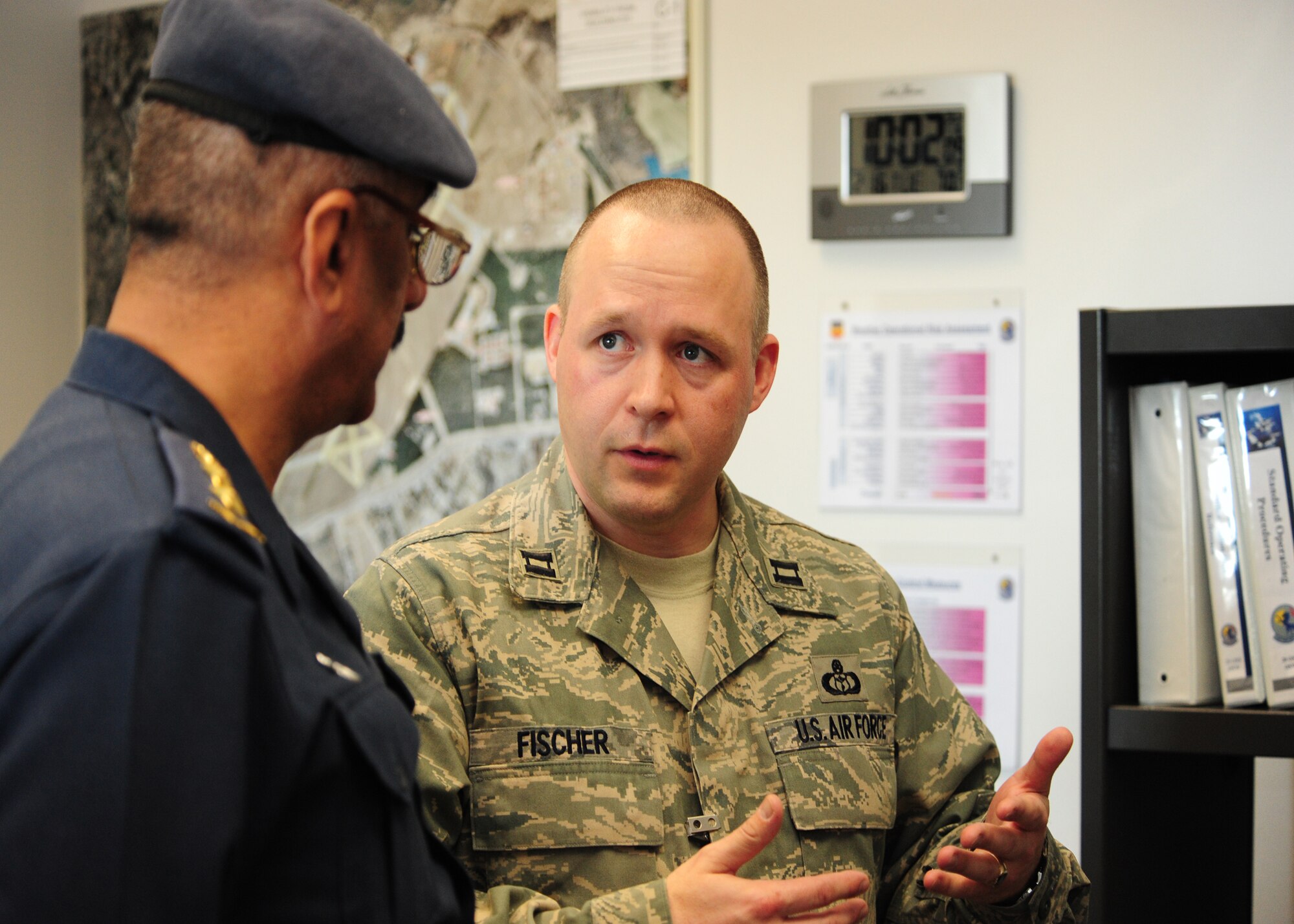 SHAW AIR FORCE BASE, S.C. -- Col. Salman (left), Iraqi Air Force Meteorological Department director and senior meteorologist, listens as Capt. David Fischer, 20th Operations Support Squadron weather flight commander, explains the 20th OSS mission Feb. 16.  Colonel Salman develops doctrine, policy, requirements and standards to organize, train and equip the meteorological department to support the Iraqi Air Force as well as the ministry of defense and other government of Iraq agencies. (U.S. Air Force photo/2nd Lt. Tony Richardson)