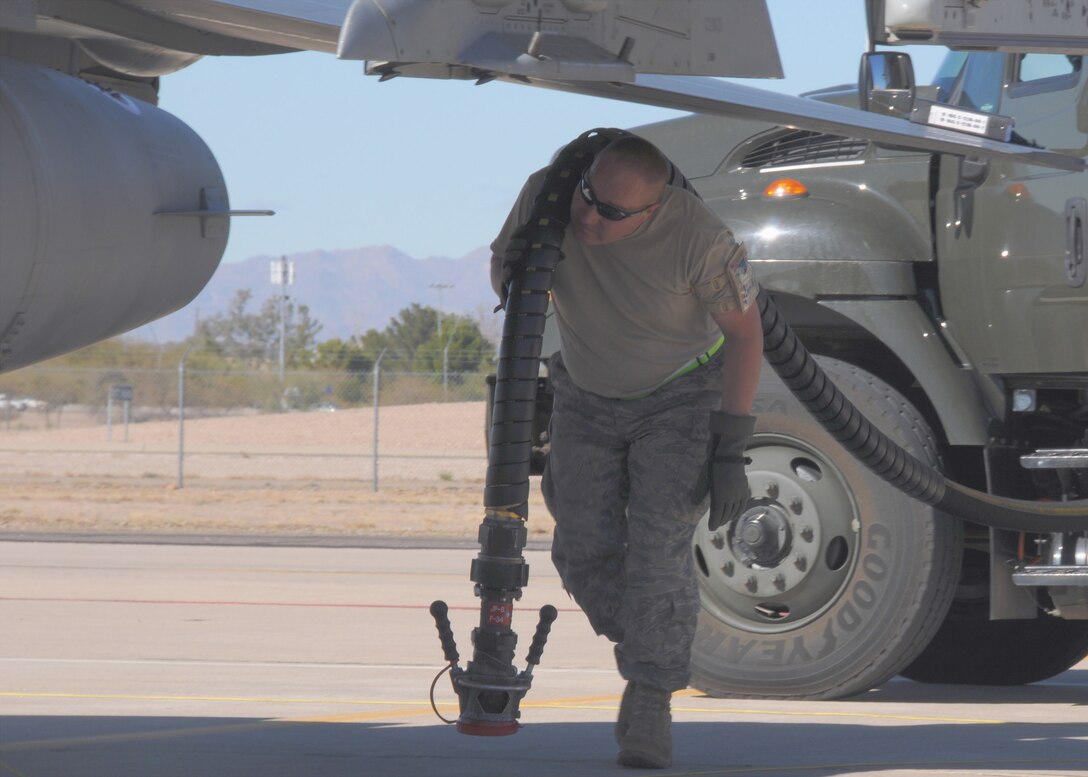 U.S. Air Force MSgt John Seymour assigned to the 158FW, Vermont Air National Guard, South Burlington, VT, carries a fuel hose to an F-16. U.S. Air Force MSgt John Seymour assigned to the 158FW, Vermont Air National Guard, South Burlington, VT, carries a fuel hose to an F-16. Seymour is responsible for refueling the F-16s as part of Operation Snowbird at Davis-Monthan Air Force Base, Tucson, AZ, January 20, 2010. (U.S. Air Force photo by A1C Sarah Mattison/Released)

 an F-16 as part of Operation Snowbird at Davis-Monthan Air Force Base