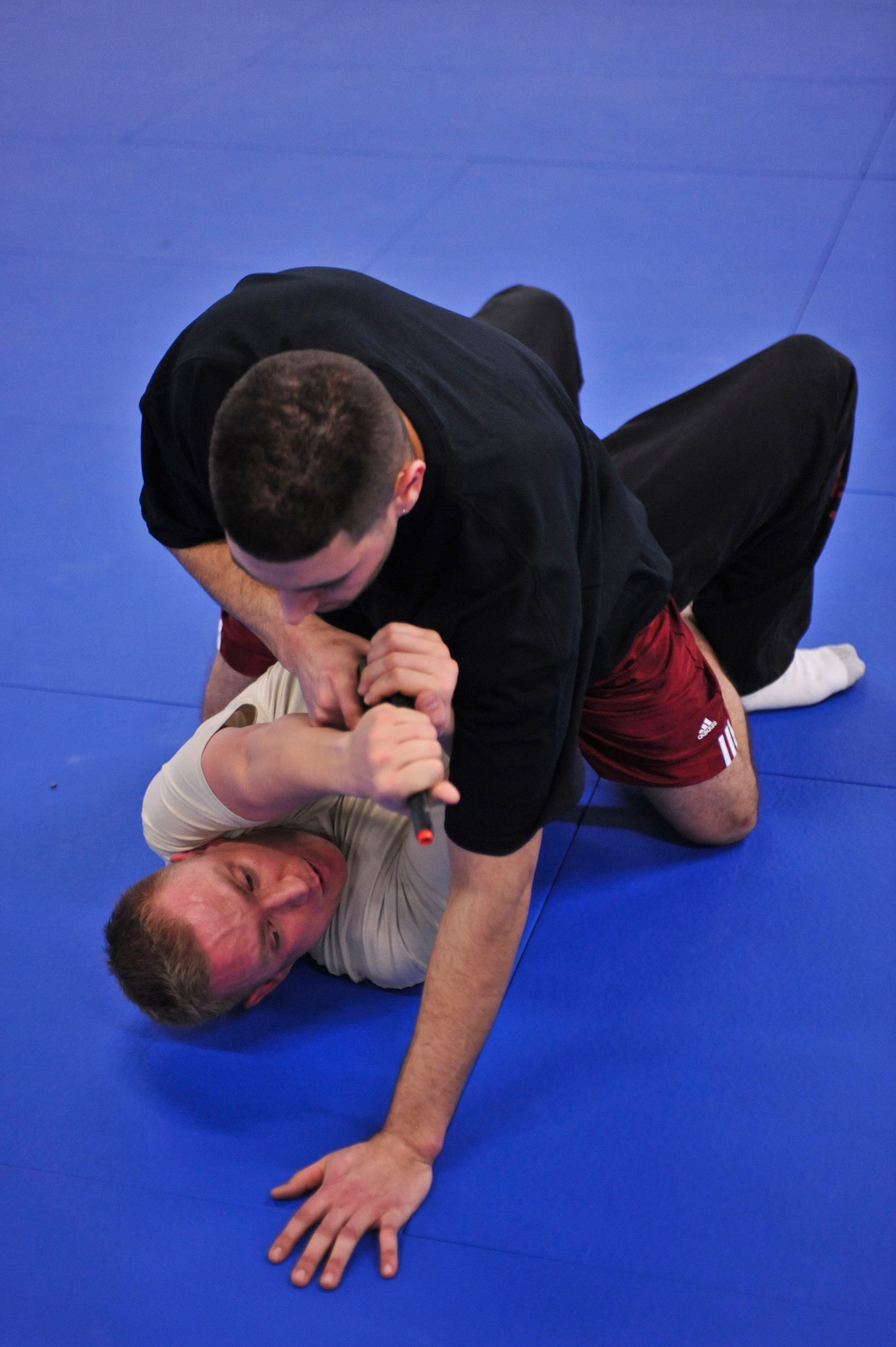FORT RICHARDSON, Alaska – Jeremy Alf works with Jeremy Robinson, 3rd Medical Group, on how to dislodge a gun and throw the attacker off when pinned on his back. Alf, who works in the 3rd MDG as a cardiopulmonary technician, teaches Krav Maga Mondays from 6-8 p.m. at Fort Richardson’s Geronimo gym. (Air Force photo by Airman 1st Class Christopher Gross)  