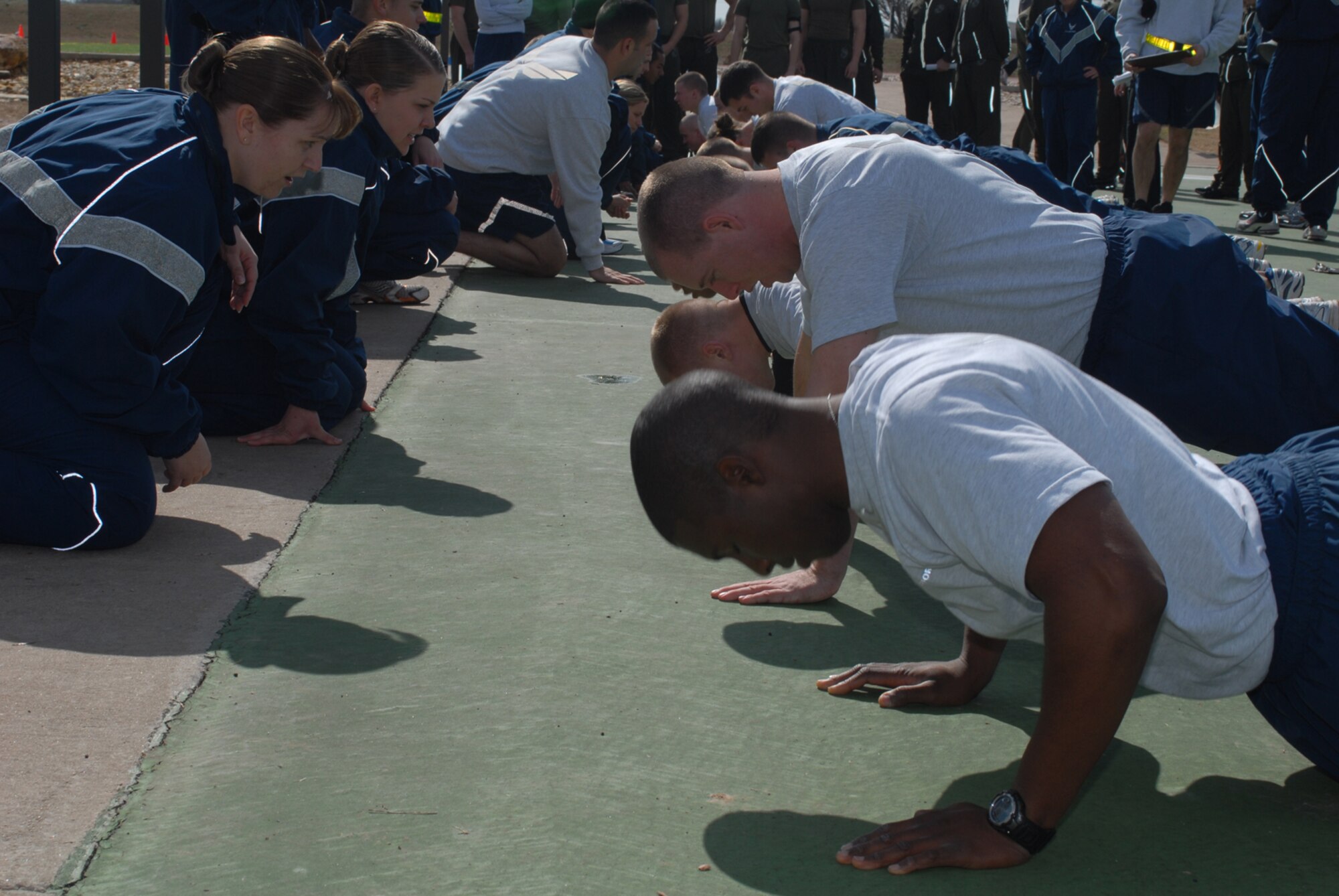 GOODFELLOW AIR FORCE BASE, Texas -- Members of the 316th Training Squadron perform push-ups during sports day, Feb. 12, 2010. Sports day provided a variety of activities for all participants including volleyball, tennis, dodge ball and more. (U.S. Air Force photo/Staff Sgt. Laura R. McFarlane)
