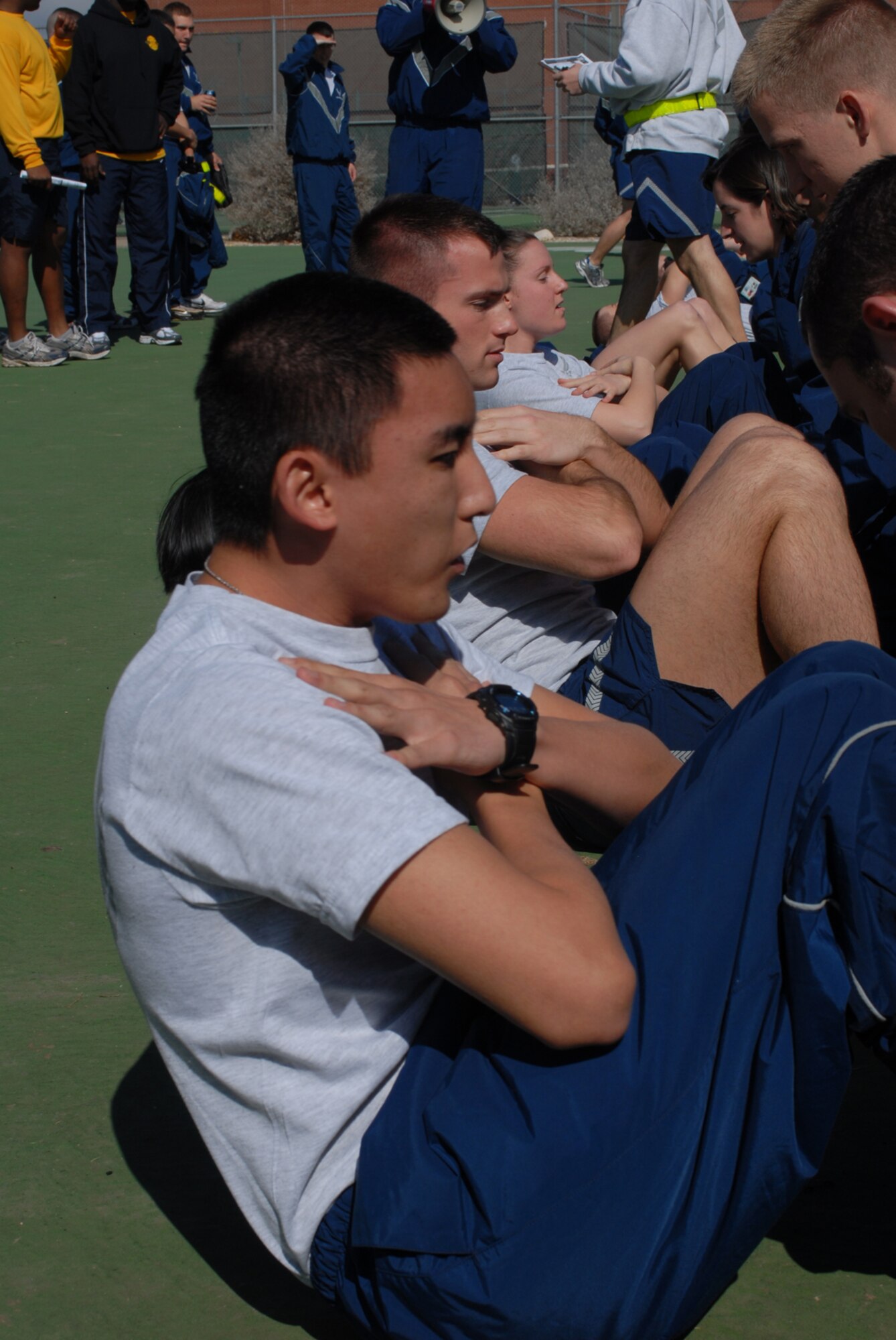 GOODFELLOW AIR FORCE BASE, Texas -- 2nd Lt. Ji Park, a student from the 315th Training Squadron, performs sit-ups alongside fellow students during sports day, Feb. 12, 2010. Sports day provided a variety of activities for all participants including volleyball, tennis, dodge ball and more. (U.S. Air Force photo/Staff Sgt. Laura R. McFarlane)
