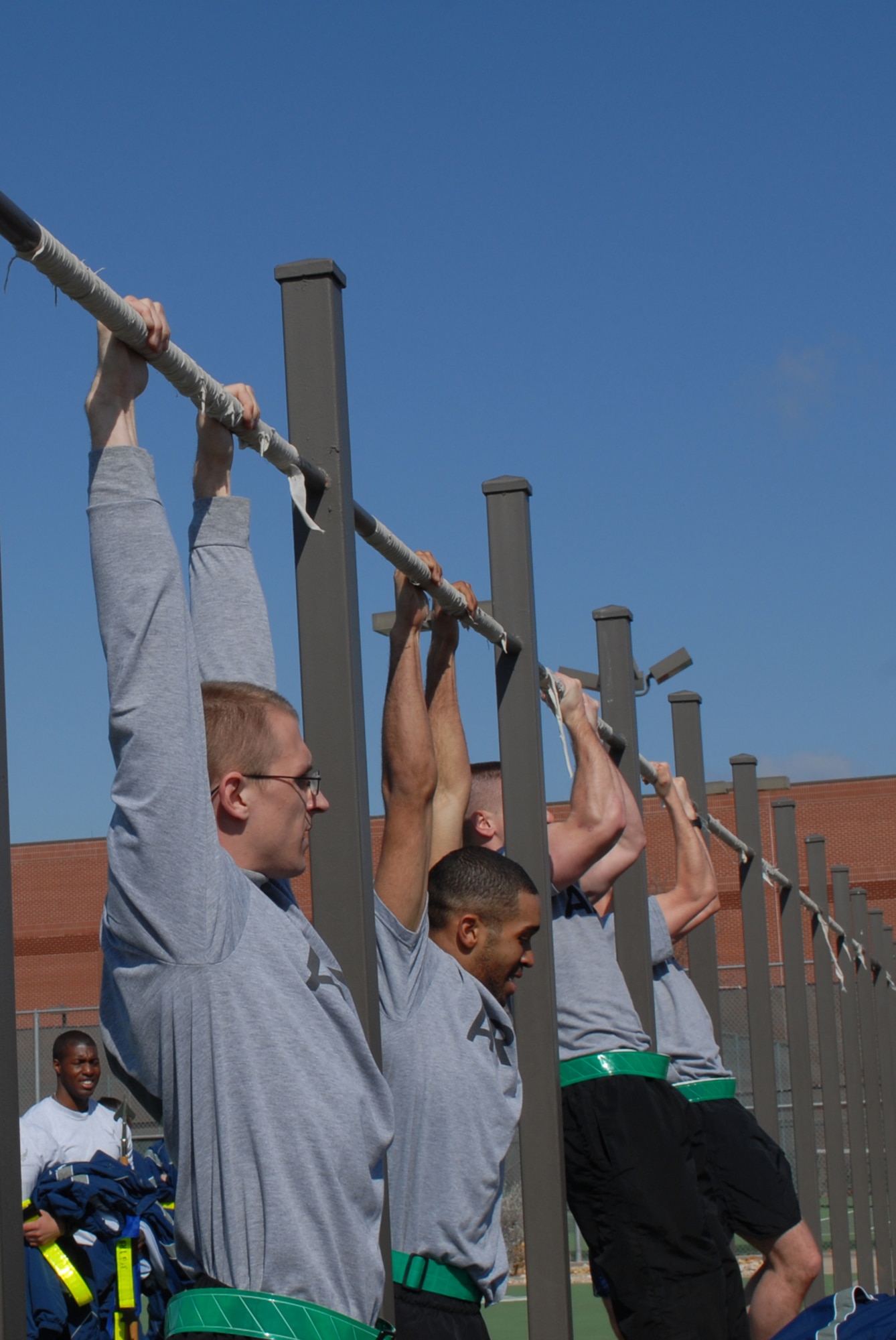 GOODFELLOW AIR FORCE BASE, Texas -- Soldiers from the 344th Military Intelligence Battalion perform pull-ups during sports day, Feb. 12, 2010. Sports day provided a variety of activities for all participants including volleyball, tennis, dodge ball and more. (U.S. Air Force photo/Staff Sgt. Laura R. McFarlane)
