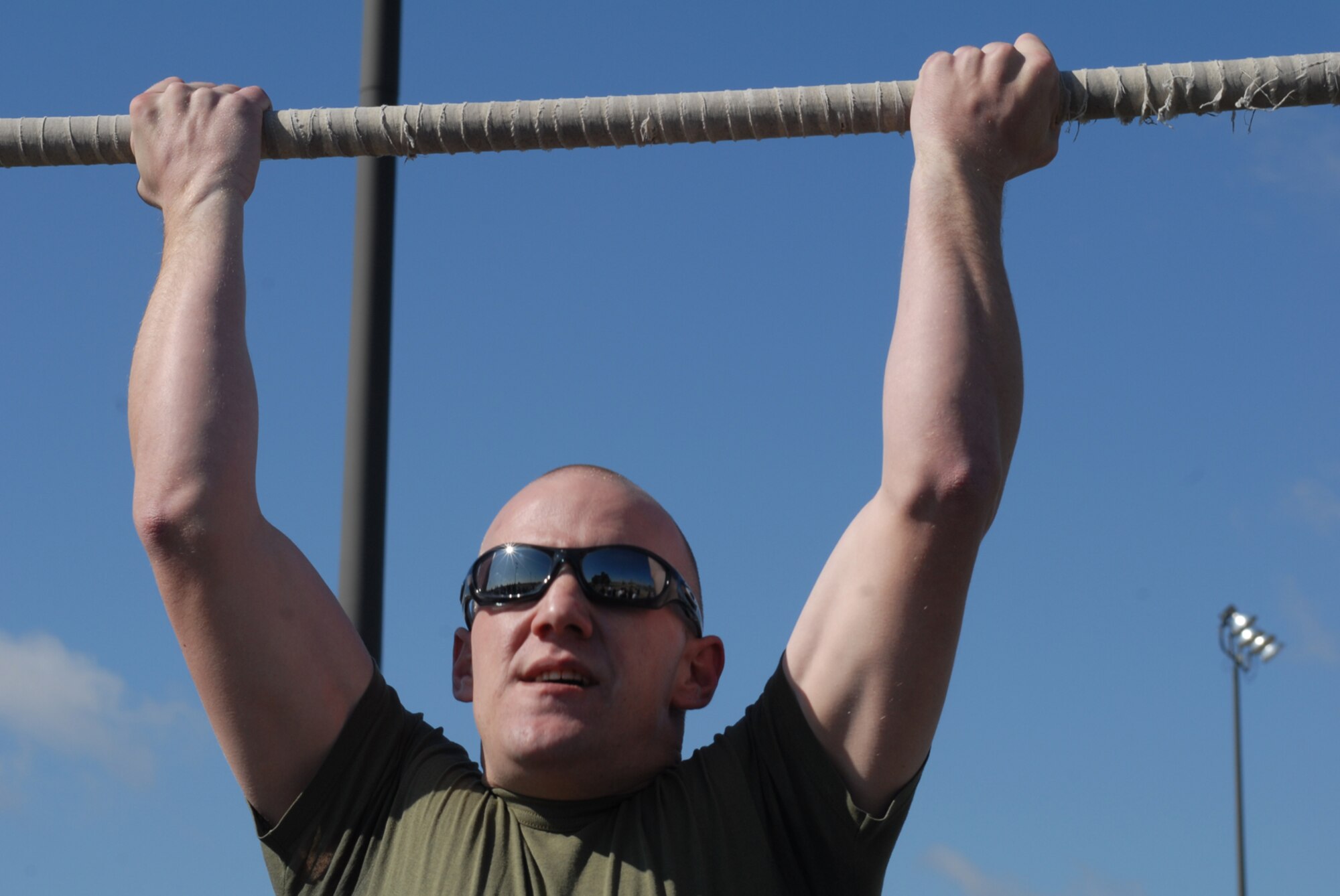 GOODFELLOW AIR FORCE BASE, Texas -- Marine Staff Sgt. Jason Nickel, Marine Corps Detachment, performs pull-ups during sports day, Feb. 12, 2010. Sports day provided a variety of activities for all participants including volleyball, tennis, dodge ball and more. (U.S. Air Force photo/Staff Sgt. Laura R. McFarlane)
