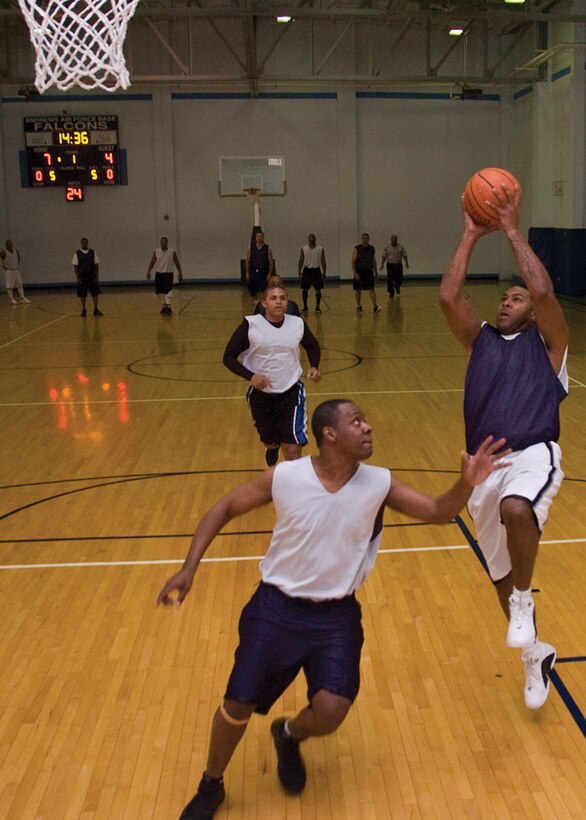 Cliff Jones, 316th Civil Engineer Squadron forward, goes in for two points in the opening minutes of the basketball see-saw contest against the 779th Medical Group at Joint Base Andrews, Md. 316 CES made a two-point shot at the buzzer to win the game 60-58. (U.S. Air Force photo by Bobby Jones)