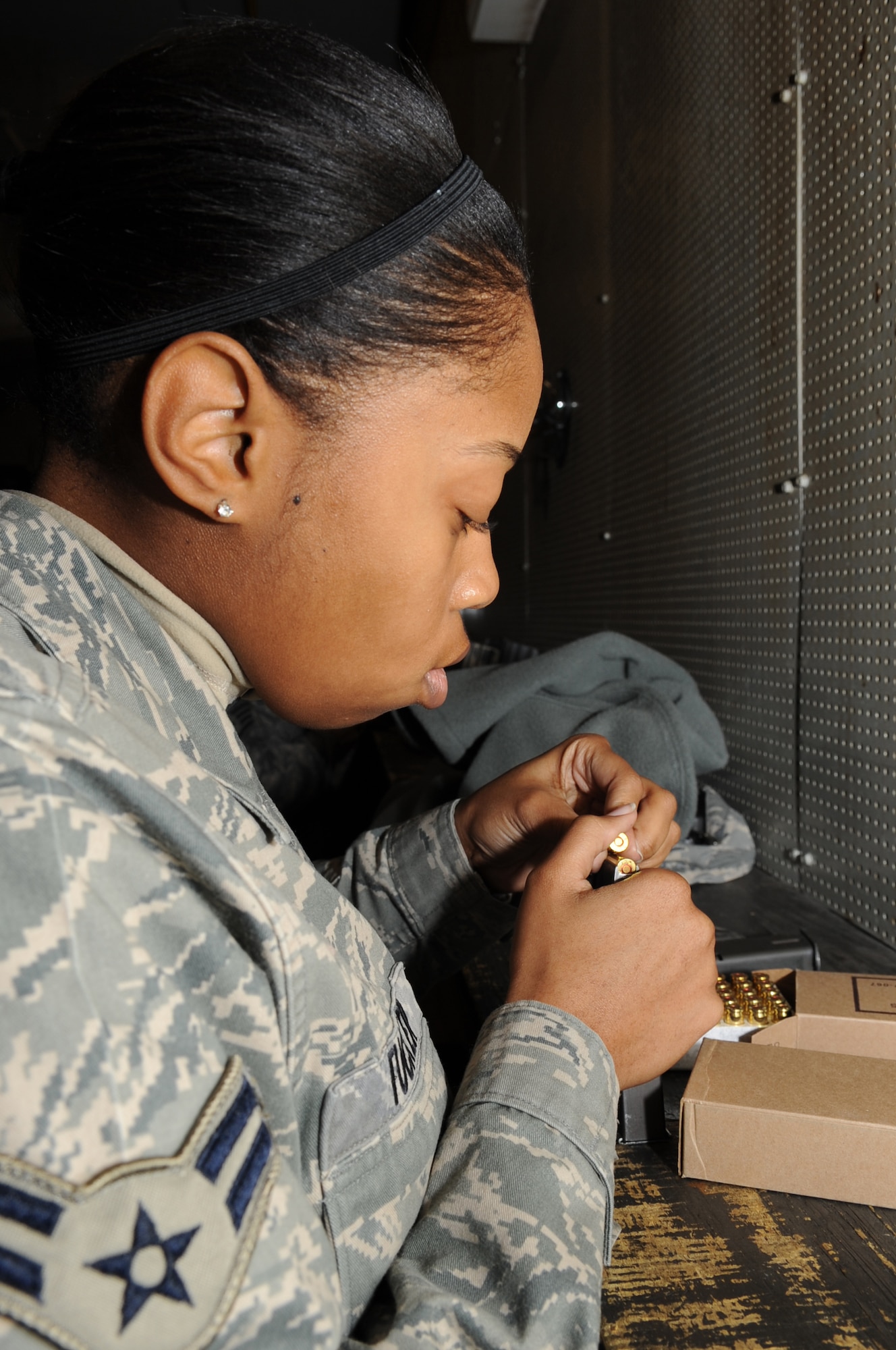 Airman 1st Class Marissa Tucker, 4th Fighter Wing Public Affairs journalist, loads ammo into M-9 magazines during training on Seymour Johnson Air Force Base, N.C., Feb. 12, 2010. Prior to deploying, all Airmen must attend training and qualify on their required weapons. (U.S. Air Force photo/ Staff Sgt. Courtney Richardson)