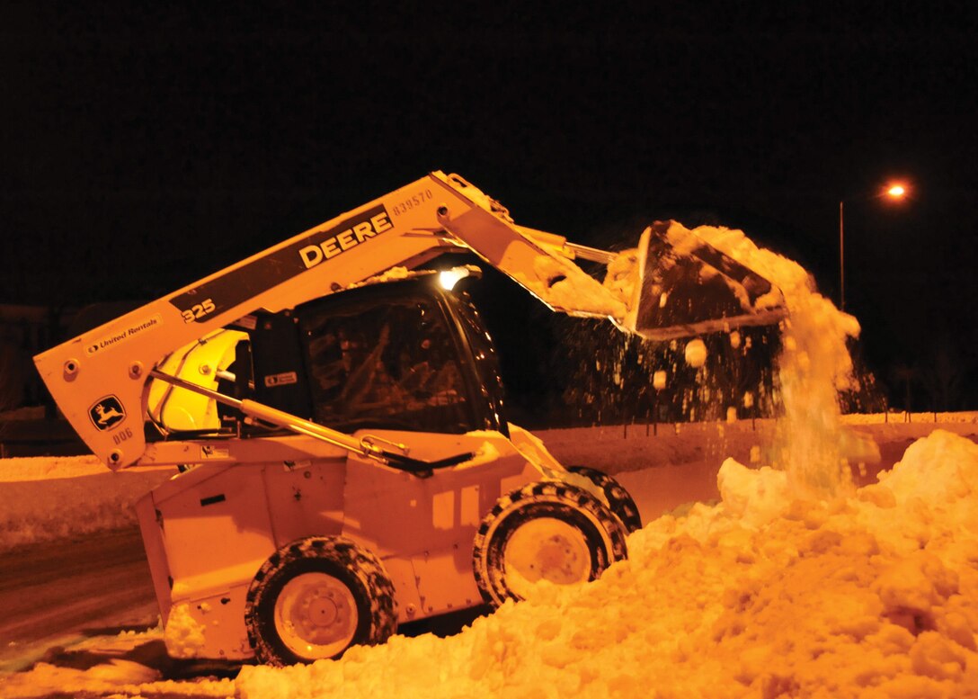 A 316th Civil Engineer Squadron snow removal team front-end loader clears out a main entrance point into Joint Base Andrews, Md., Feb. 8, 2010 after a weekend blizzard struck the D.C. area. (U.S. Air Force photo by Bobby Jones)