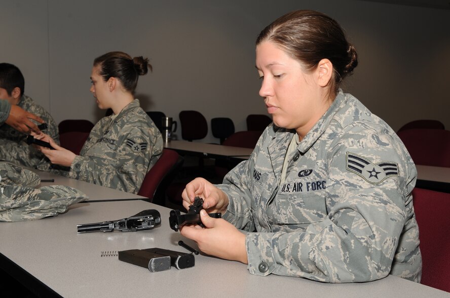 SEYMOUR JOHNSON AIR FORCE BASE, N.C. -- Senior Airman Mallory Burrous, 916th Air Refueling Wing aircrew flight equipment reservist, inserts the barrel into the slide assembly of an M-9 during training, Feb. 12, 2010. The slide assembly consists of the decocking lever, firing pin, extractor, barrel, firing pin block, locking block and sights. Airman Burrous is from Swansboro, N.C. (U.S. Air Force photo/Staff Sgt. Courtney Richardson)