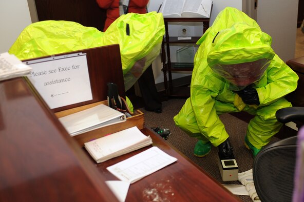 WHITEMAN AIR FORCE BASE, Mo. - Staff Sgt. Michael Moore (Left) and Ricky Sponseller, Whiteman Fire Department, monitor readings from an envelope containing a simulated suspicious substance received by mail for the massive accident response exercise Feb. 10, 2010. Emergency response teams reacted to the simulated 9-1-1 call and were evaluated  on response procedures and team proficiency. (U.S. Air Force photo/Tech. Sgt. Charles Larkin Sr)