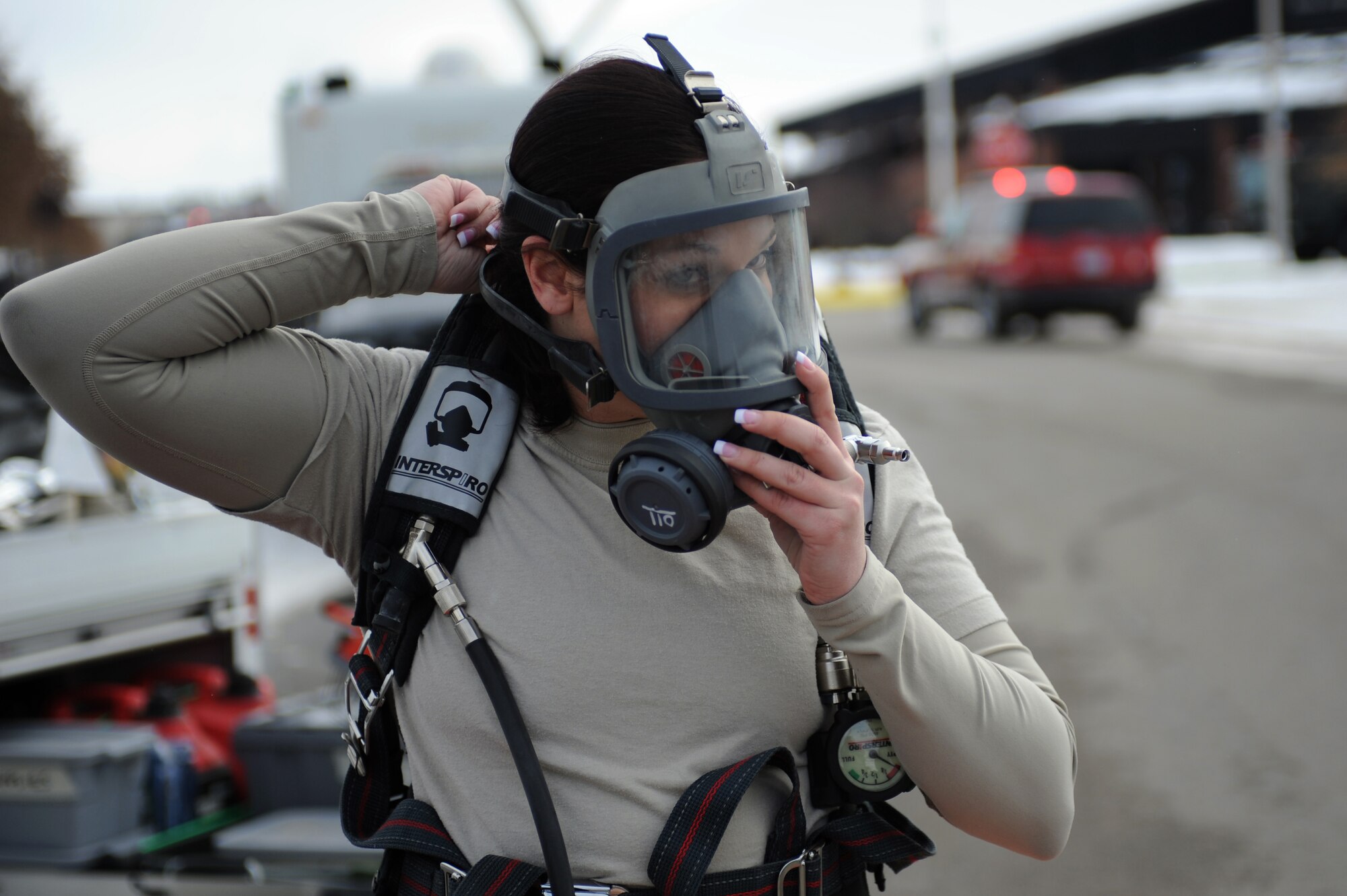 WHITEMAN AIR FORCE BASE, Mo. - Staff Sgt. Brandi Baker, 509th Civil Engineer Squadron emergency management technician, dons a respirator during a massive accident response exercise Feb. 10, 2010. Emergency Management responded to the exercise event in reaction to a simulated 911 call about a suspicious substance received by mail for the exercise. (U.S. Air Force photo/Tech. Sgt. Charles Larkin Sr)
