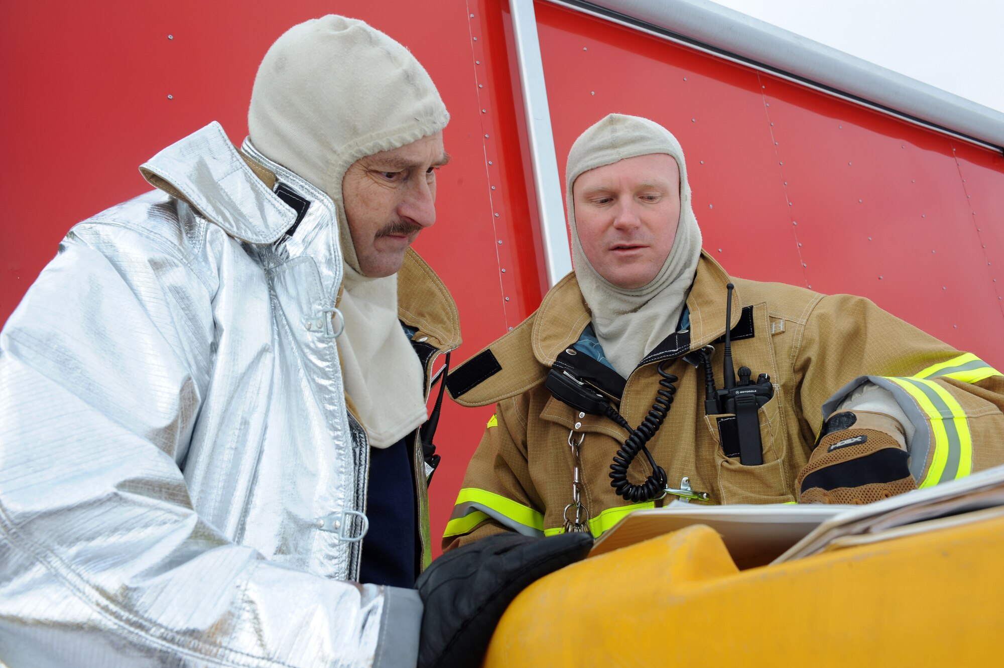 WHITEMAN AIR FORCE BASE, Mo. - Blake Calvin (left) and Rick Stroud, Whiteman Fire Deptartment, review procedures for emergency decontamination during a massive accident response exercise Feb. 10, 2010. Whiteman Air Force Base emergency response teams reacted to a simulated suspicious substance received by mail for the exercise. (U.S. Air Force photo/Tech. Sgt. Charles Larkin Sr)
