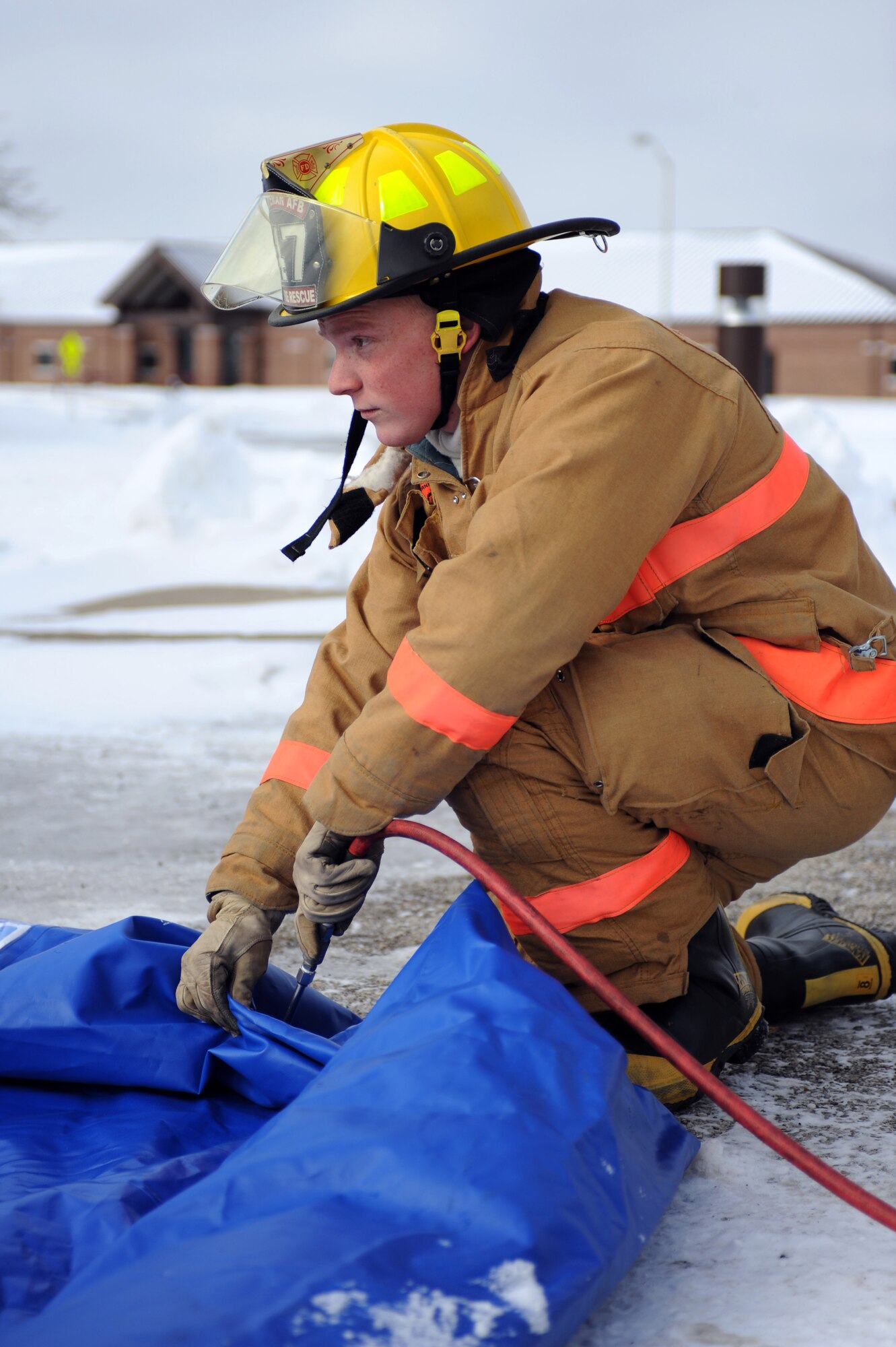 WHITEMAN AIR FORCE BASE, Mo. - Airman 1st Class David Lawhead, Whiteman Fire Deptartment, inflates a mobile emergency decontamination station during a massive accident response exercise Feb. 10, 2010. Whiteman Air Force Base emergency response teams reacted to a simulated suspicious substance received by mail for the exercise. (U.S. Air Force photo/Tech. Sgt. Charles Larkin Sr)