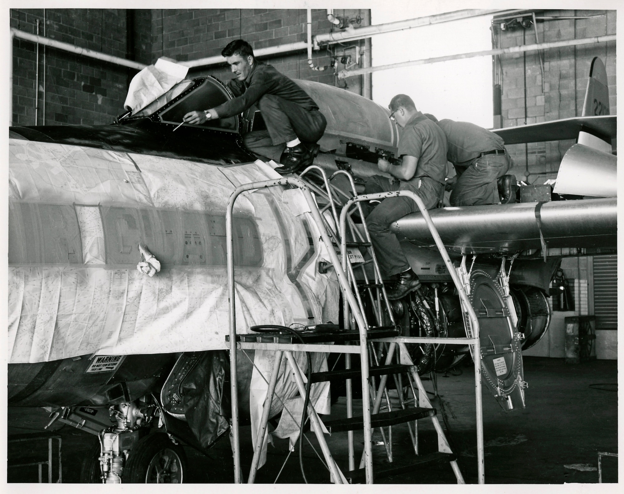 Maintenance crews from the 128th Fighter Interceptor Squadron,  Wisconsin Air National Guard work on an F89 "Scorpion" in the units hangar on Howell Ave. The 128th flew the F89 during the 1950s till 1962.
