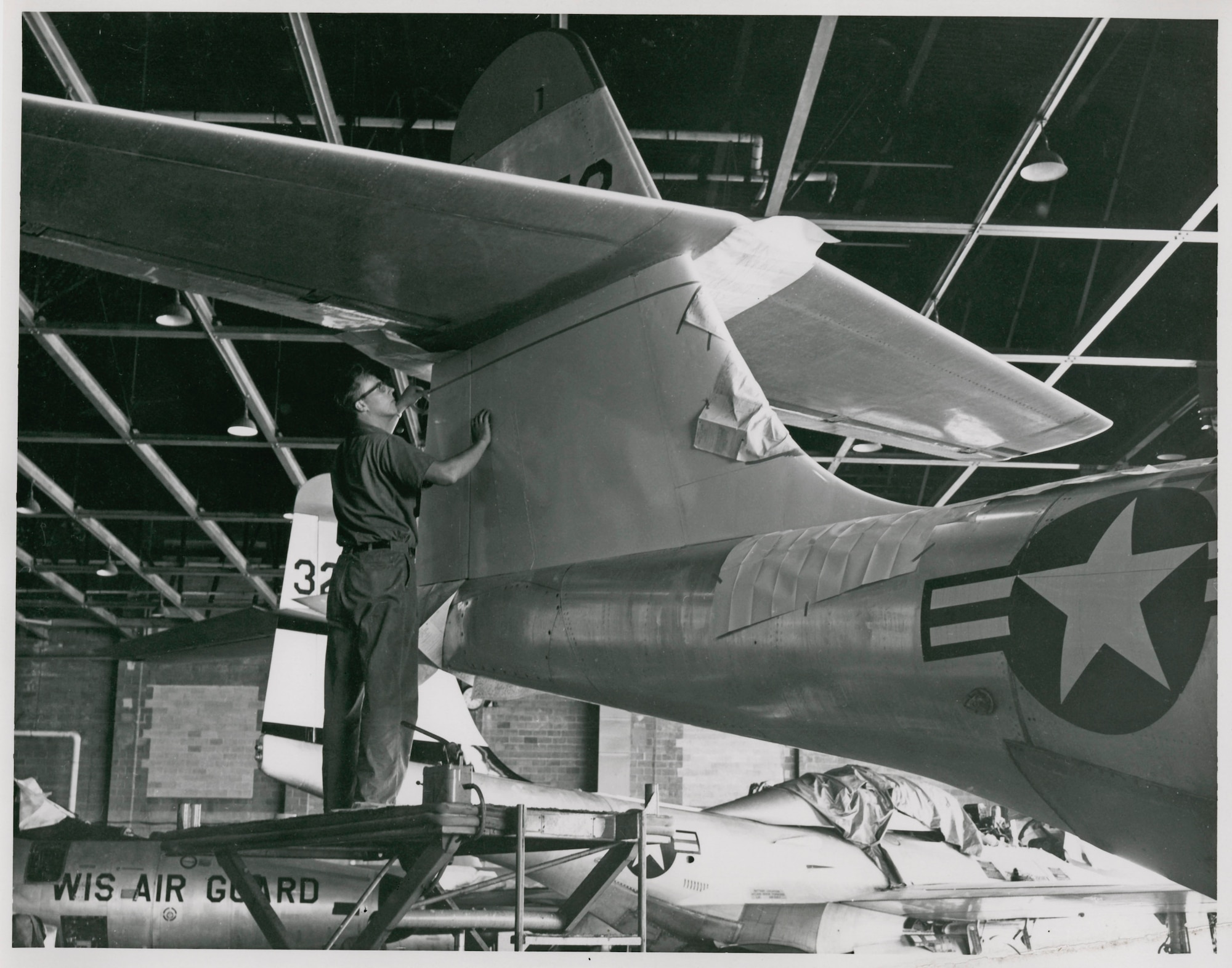 Maintenance crews from the 128th Fighter Interceptor Squadron,  Wisconsin Air National Guard work on an F89 "Scorpion". The 128th flew the F89 during the 1950s till 1962.
