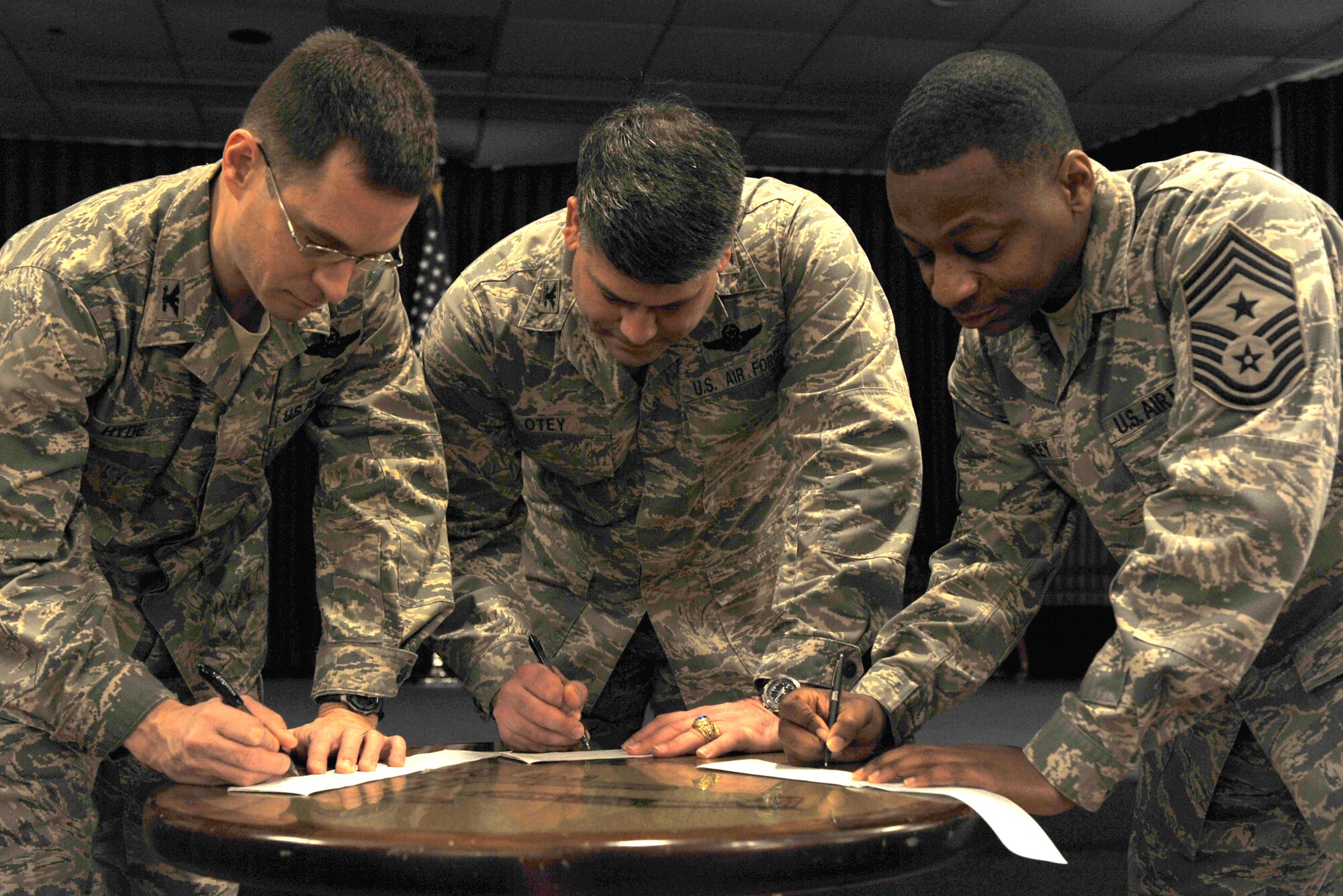 Col. C.K. Hyde, 314th Airlift Wing commander; Col. Greg Otey, 19th Airlift Wing commander; and Chief Master Sgt. Anthony Brinkley, 19th Airlift Wing command chief; fill out a 2561 contribution form for the Air Force Assistance Fund Feb. 11.  AFAF kicked off Feb. 8 and runs through March 19. The goals for the base are 100 percent contact, $90,654 contribution amount and 50 percent participation. (U.S. Air Force photo by Senior Airman Christine Clark)