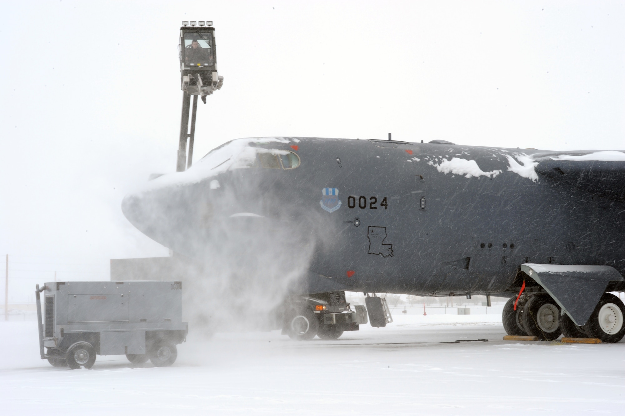 MINOT AIR FORCE BASE, N.D. – A B-52H Stratofortress is de-iced during pre-flight preparations Feb. 5. De-icing the aircraft is a vital procedure essential to maintaining a safe, secure and reliable takeoff. (U.S. Air Force photo by Senior Airman Jesse Lopez)