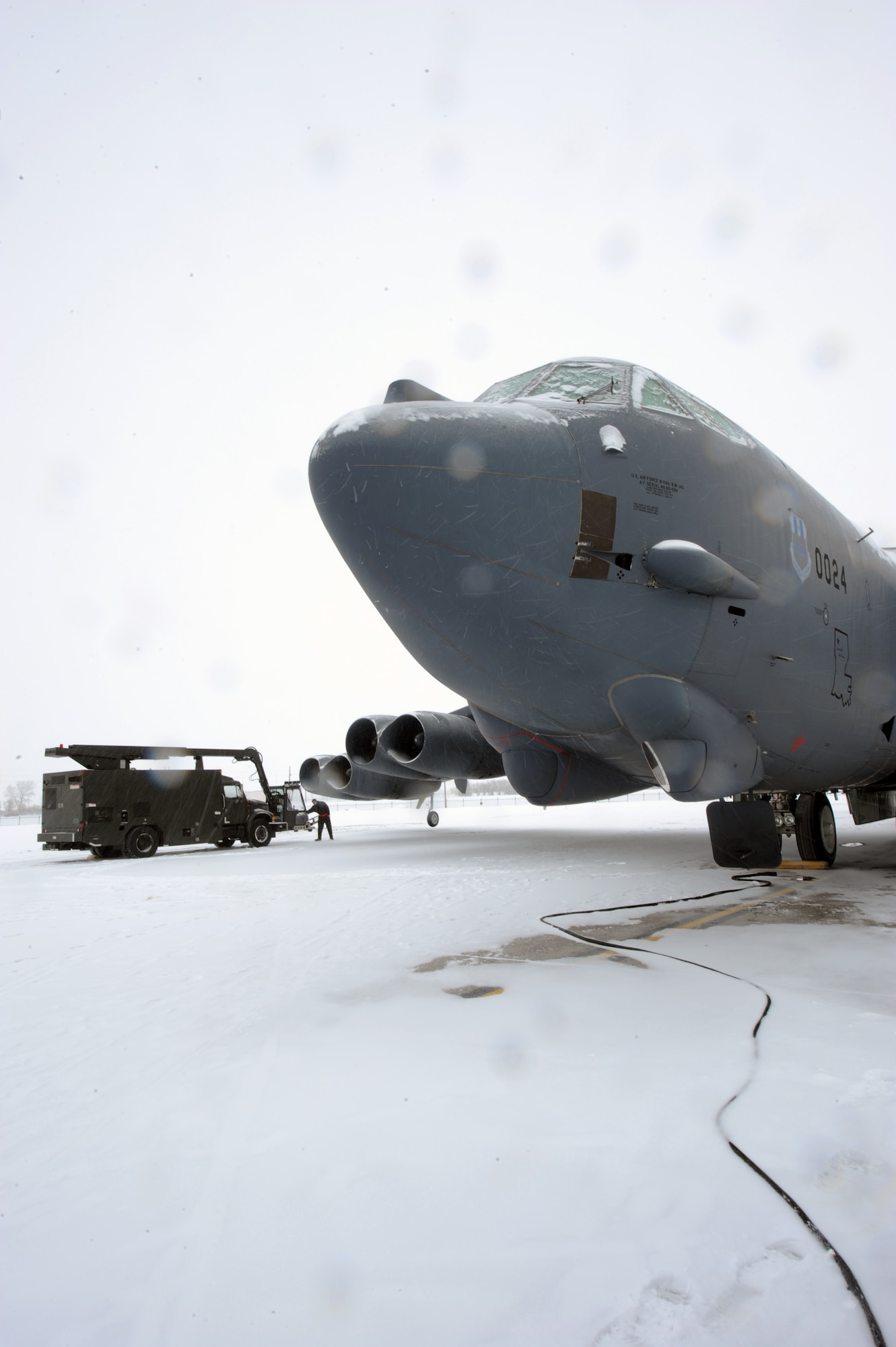 MINOT AIR FORCE BASE, N.D. – Senior Airman Matthew McAllister, 5th Aircraft Maintenance Squadron crew chief, de-ices a B-52H Stratofortress during pre-flight preparations Feb. 5. De-icing the aircraft is a vital procedure essential to maintaining a safe, secure and reliable takeoff. (U.S. Air Force photo by Senior Airman Jesse Lopez)