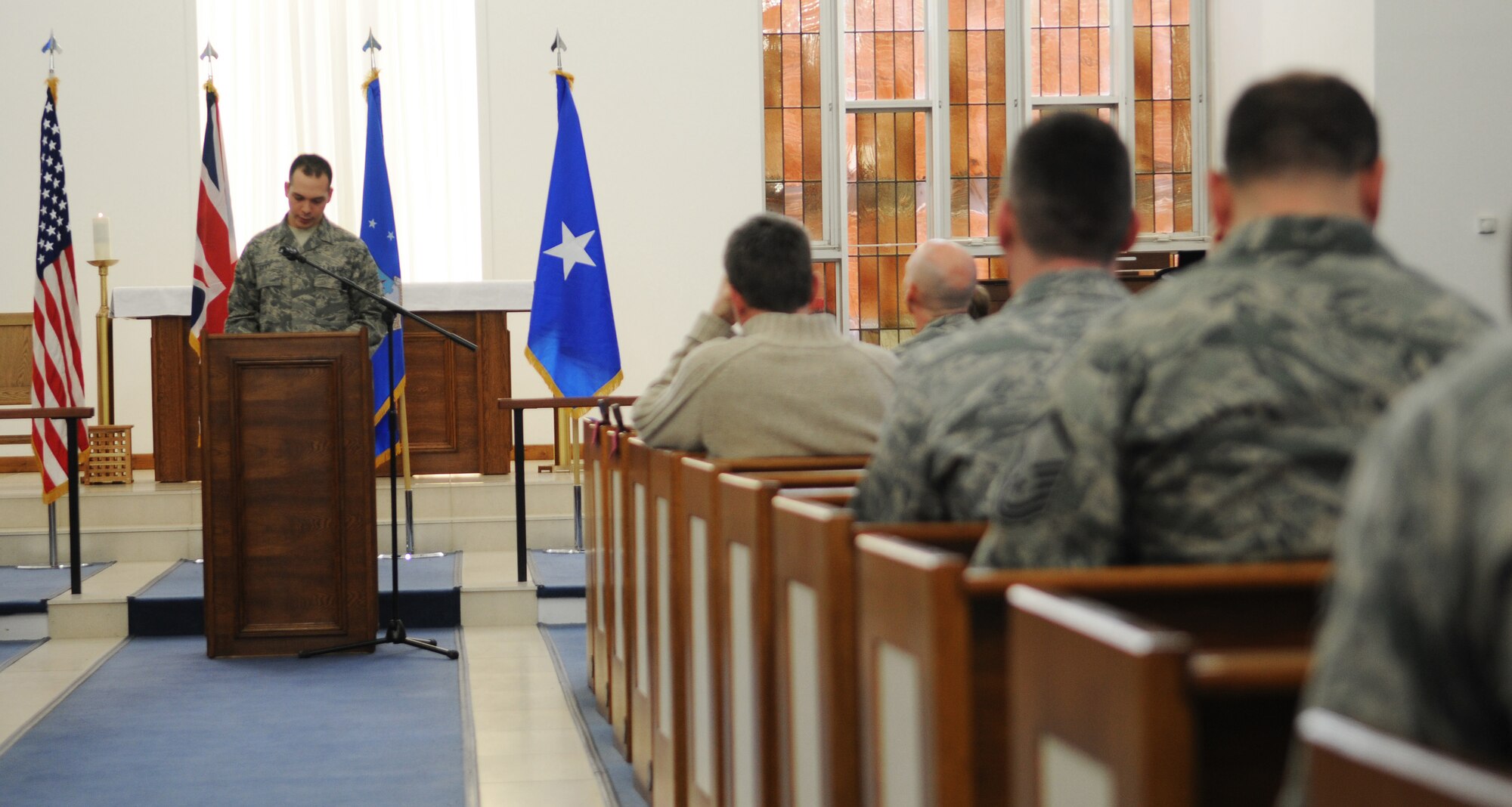 RAF MILDENHALL, England -- Senior Airman Elad Levy, 3rd Air Force, reads a Hebrew scripture at the annual RAF Mildenhall National Prayer Luncheon Feb. 12 at the 100th Air Refueling Wing Chapel. Chap. (Brig. Gen.) David Cyr, Air Force deputy chief of chaplains, was this year's guest speaker and focused on the theme, "God, bless America." (U.S. Air Force photo/Senior Airman Thomas Trower)