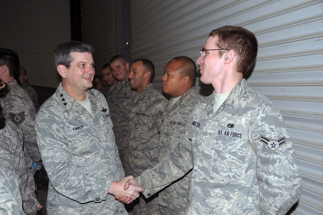 Lt. Gen. Rusty Findley, vice commander of Air Mobility Command at Scott Air Force Base, Ill., greets Airman 1st Class Michael Multer, a KC-10 maintenance Airman with the 380th Expeditionary Aircraft Maintenance Squadron during General Findley's visit to the 380th Air Expeditionary Wing at a non-disclosed base in Southwest Asia on Feb. 11, 2010.  General Findley stopped at the 380th AEW as part of a command visit to areas in the U.S. Central Command area of responsibility. Airman Multer is deployed from the 605th Aircraft Maintenance Squadron at Joint Base McGuire-Dix-Lakehurst, N.J. (U.S. Air Force Photo/Master Sgt. Scott T. Sturkol/Released)