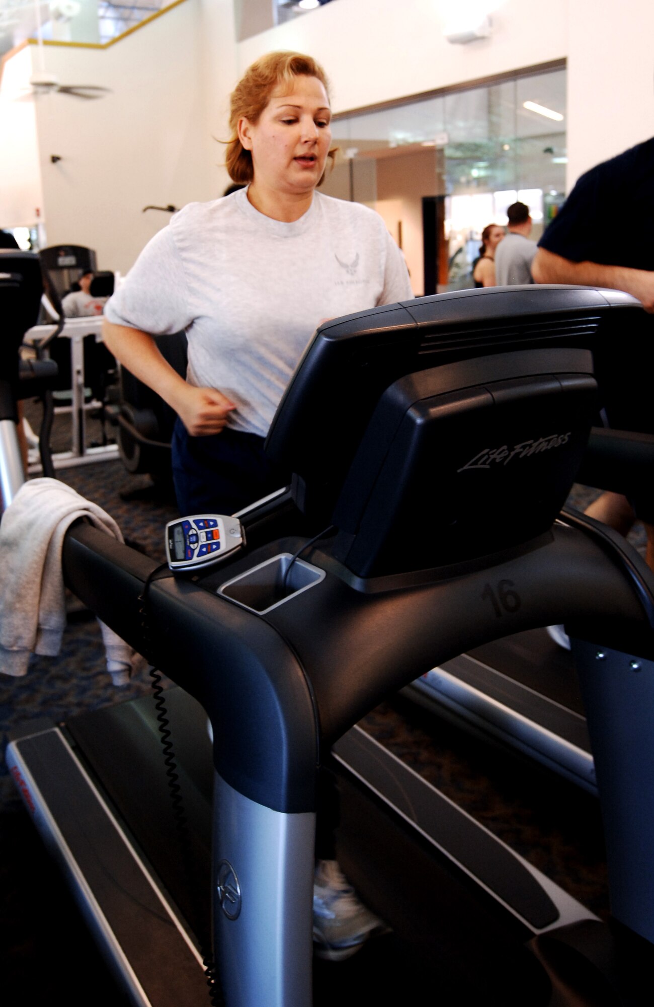 LANGLEY AIR FORCE BASE, Va. -- Maj. Kathryn Bienfang, Air Combat Command Public Affairs action officer, runs on a treadmill at the Shellbank Fitness center. Major Bienfang said finding time to work out is hard with her busy schedule, but it is essential to getting in better shape. (U.S. Air Force photo/Airman 1st Class Jason J. Brown)