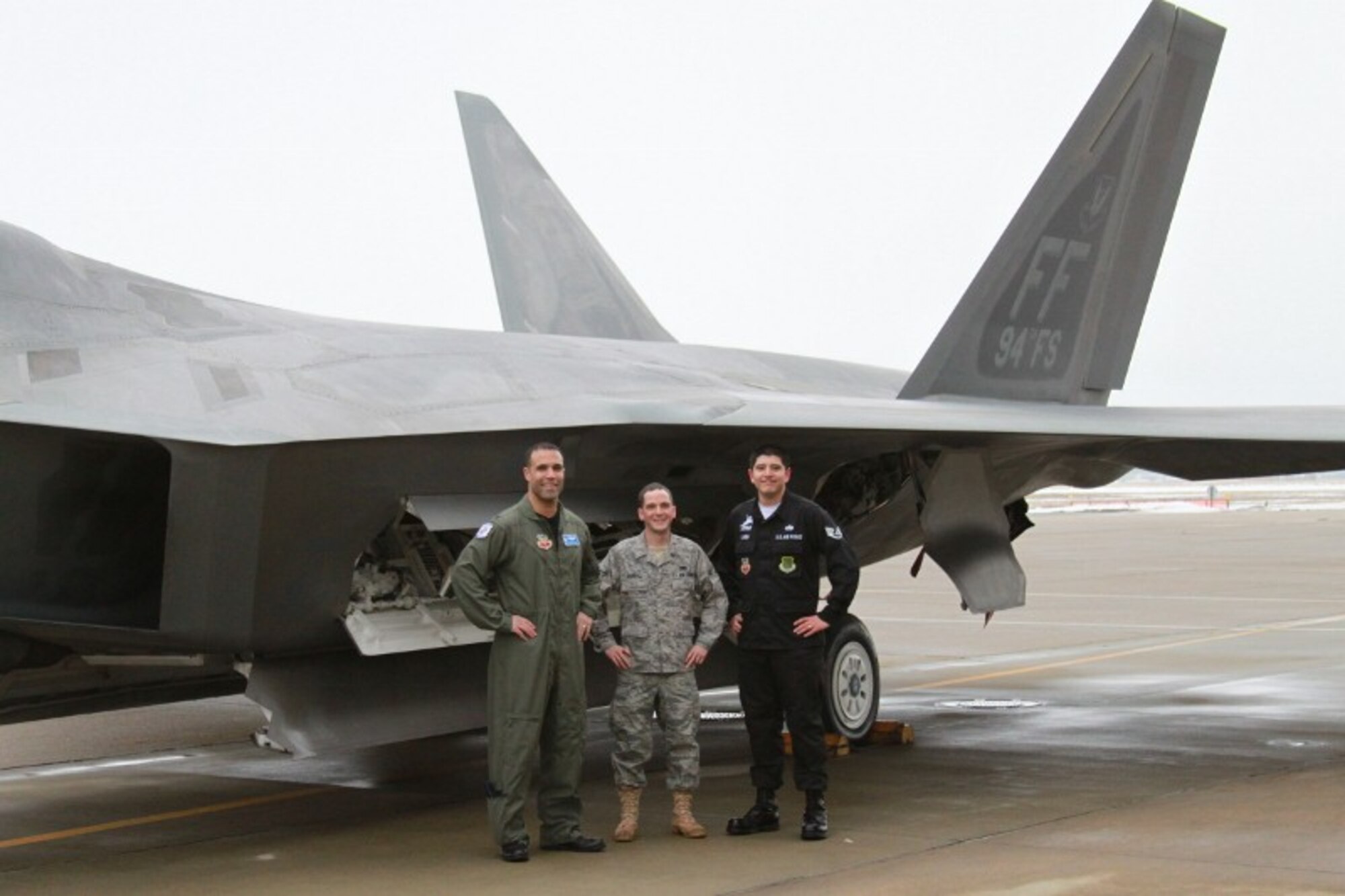 LANGLEY AIR FORCE BASE, Va. -- Lt. Col. Adrian Spain (left), 94th Fighter Squadron commander, Staff Sgt John Lugo dedicated crew chief, and Airman 1st Class Brendan Carroll assistant dedicated crew chief, stand next to the 94 FS flagship one last time prior to its departure Feb. 8.  A/C 05-094 is being transferred to Holloman Air Force Base, NM, as part of Air Combat Command's common configuration initiative and will eventually be replaced by a/c -194. (Courtesy photo)