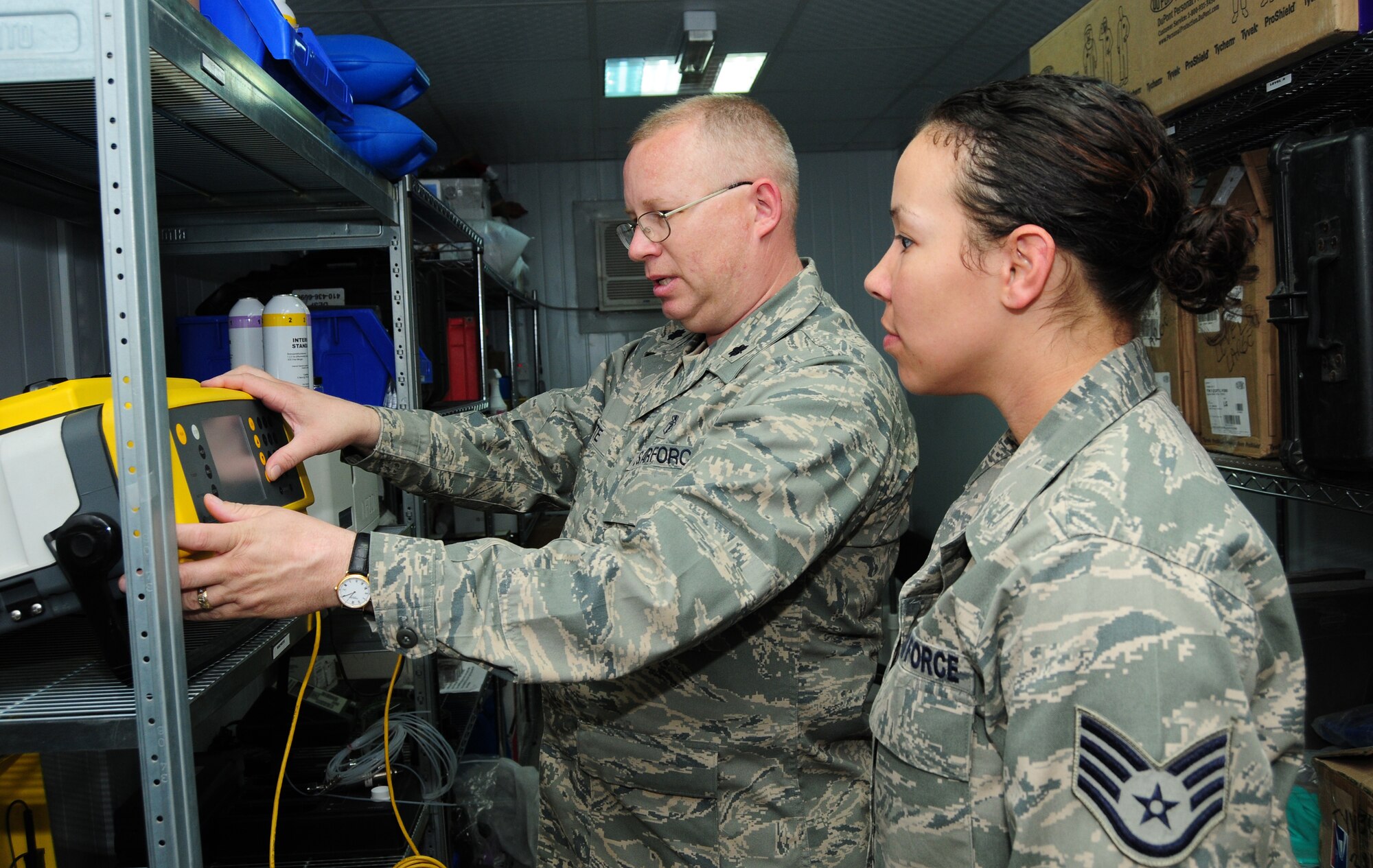 U.S. Air Force Lt. Col. Ronald Porte and Staff Sgt. Nicole Logan, both of the 386th Expeditionary Medical Group, review data from a previous sample run on the Hapsite, a gas chromatograph with a mass selective detector used to measure the concentration of volatile organic compounds in the enviornment, Feb. 15, 2010 at an air base in Southwest Asia. Colonel Porte, deployed from Eglin AFB, Fla., is part of the Air Force Medical Service Outstanding Bioenvironmental Engineering Team of the Year. (U.S. Air Force photo by Staff Sgt. Lakisha Croley/Released)    