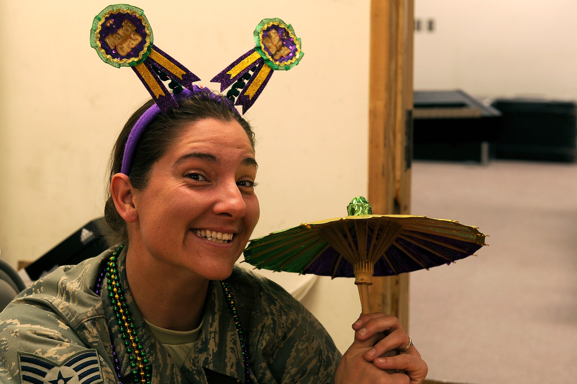U.S. Air Force Staff Sgt. Tanja Moore, 455th Expeditionary Force Support Squadron, enjoys Mardi Gras festivities at Bagram Airfield, Afghanistan, Feb. 15, 2010. Sgt Moore is deployed from Moody Air Force Base, Ga. and is from Colorado Springs, Colo. (U.S. Air Force photo by/ Tech. Sgt. Jeromy K. Cross/released)