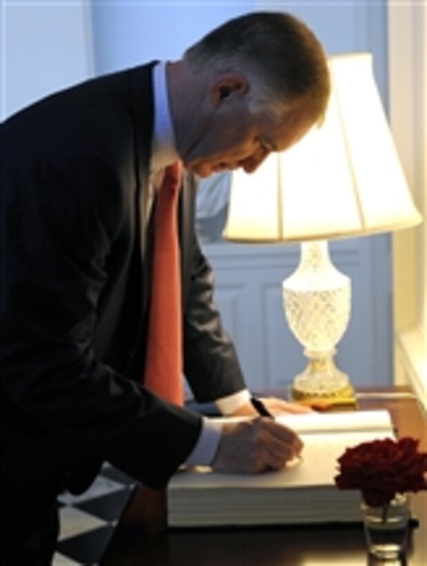 Deputy Secretary of Defense William J. Lynn III signs his name in a visitor's log at the U.S. Ambassadors home in Canberra, Australia, on Feb. 16, 2010.  