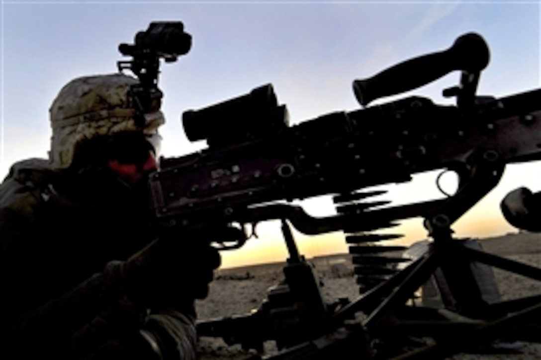 U.S. Army Spc. Jerimiah Butts mans an M-240B machine gun from a rooftop during Operation Helmand Spider in Badula Qulp, Helmand province, Afghanistan, Feb. 9, 2010. Butts is assigned to Company A, 1st Battalion, 17th Infantry Regiment.