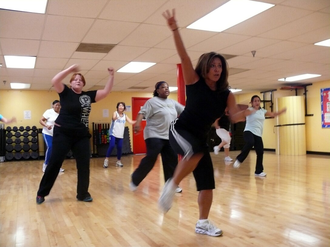 During an hour long low-impact aerobics session at the Semper Fitness Center, Barstow, Calif., native Tina Howard (foreground) takes students of all ages through their paces Feb. 16. The 40-year-old health and fitness coordinator has built a loyal following aboard Marine Corps Logistics Base Barstow for the weekly classes by helping her students meet their fitness goals in a relaxed and fun environment, while focusing on building their confidence and increasing their overall quality of living.