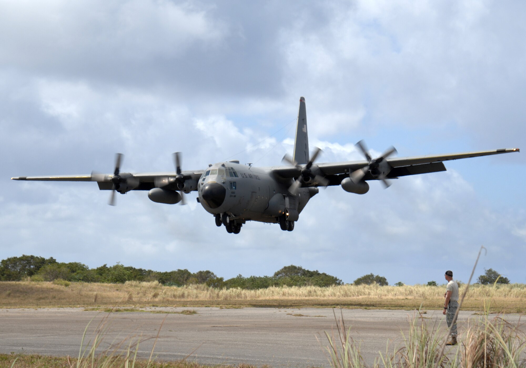 Staff Sgt. Sean Cripe, an air traffic controller with the 36th Mobility Response Squadron, watches a C-130 Hercules land at Northwest Field, next to Andersen Air Force Base, Guam, Feb. 17.  The 36th Contingency Response Group at Andersen and the 374th Operations Group from Yokota Air Base, Japan, participated in a mock deployment to Northwest Field to rehearse time-critical actions for disaster relief operations.
(USAF photo by Capt. Andrew G. Hoskinson)