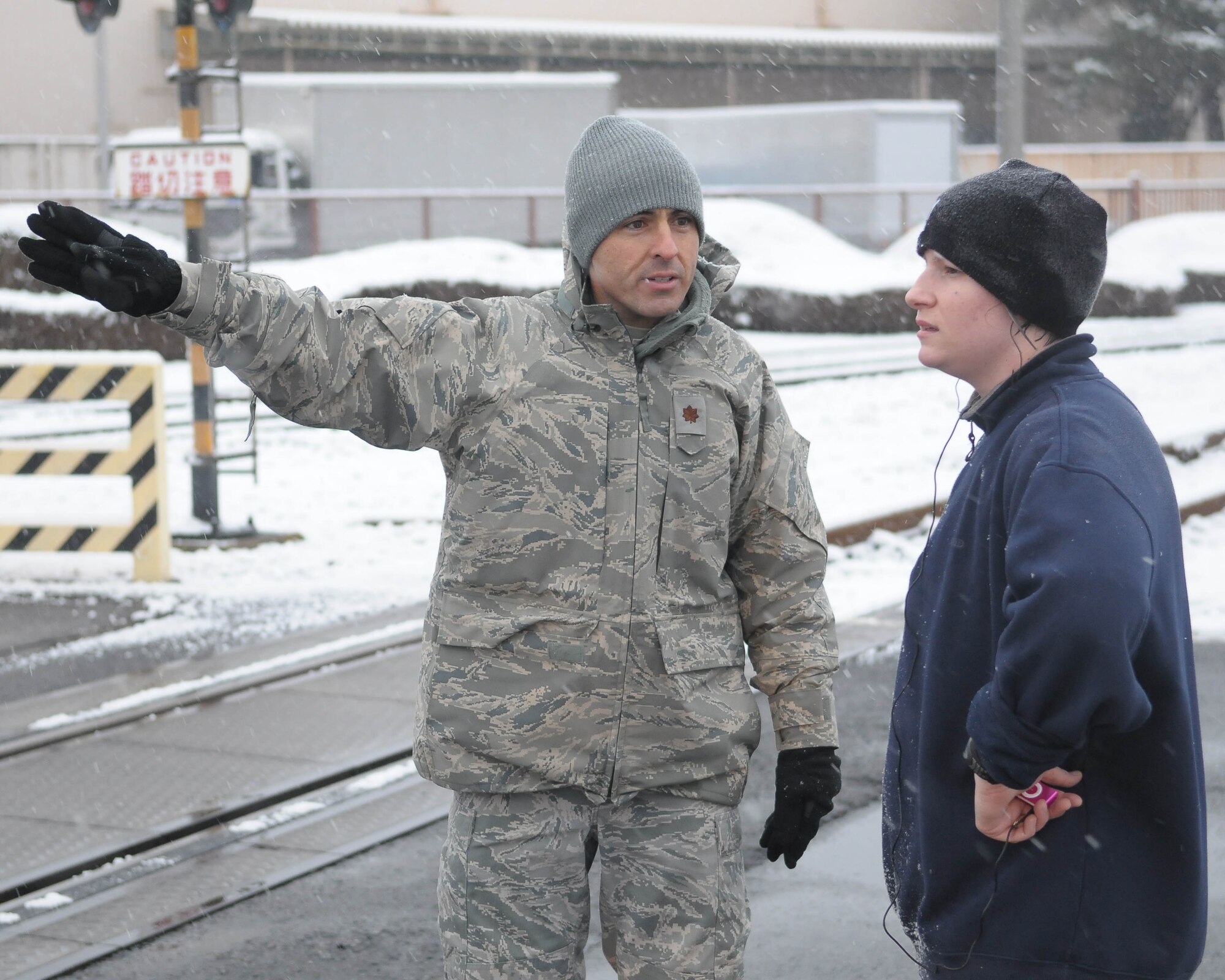 YOKOTA AIR BASE, Japan -- Major Joseph Williams, 374th Medical Surgical Operations, describes the course to a runner Feb. 18 during the Warrior Run Program. The purpose of the program is to ensure that airmen have all the tools needed to meet physical fitness standards.. (U.S. Air Force photo/Airman 1st Class Sean Martin)