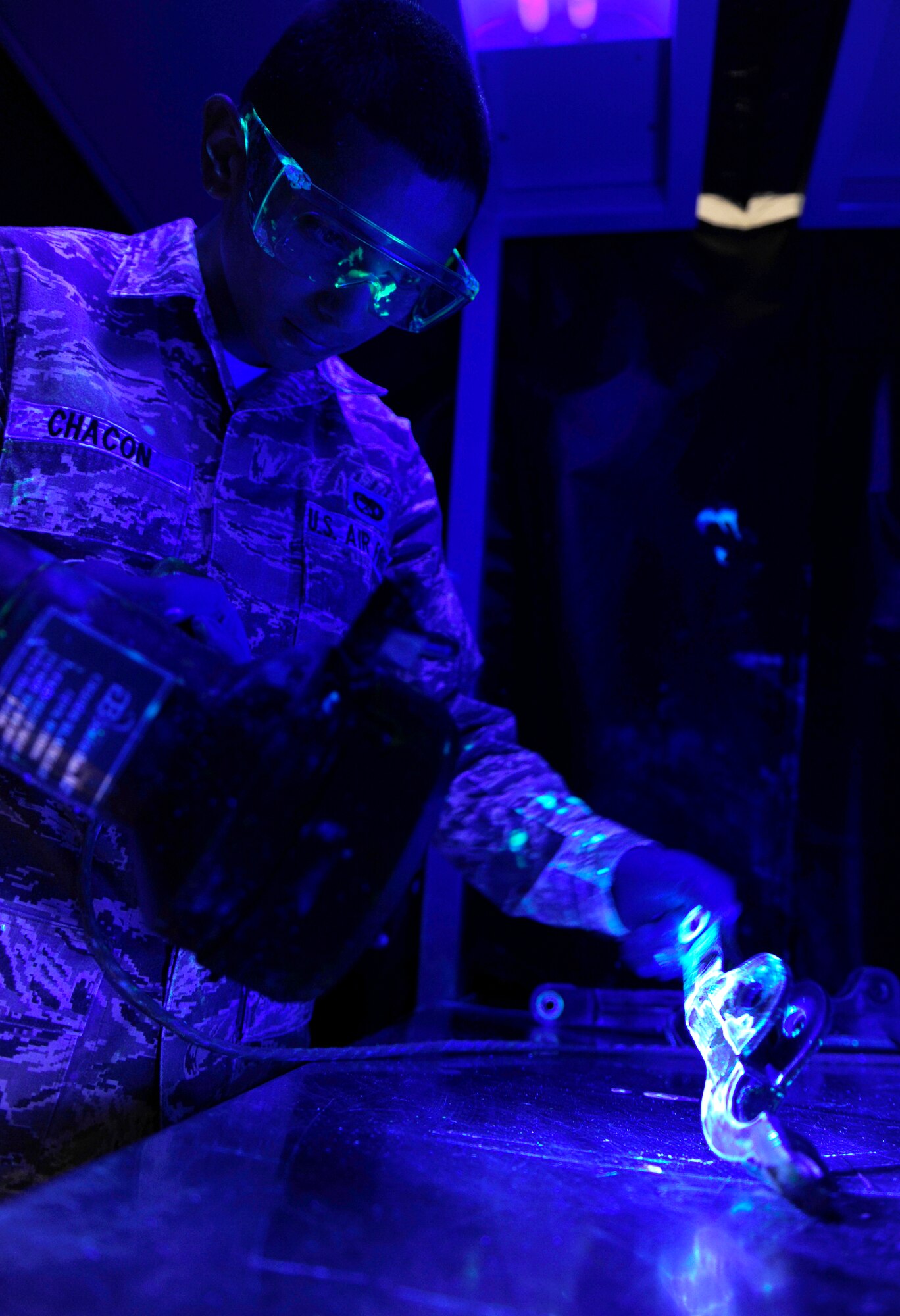 HOLLOMAN AIR FORCE BASE, N.M. -- Airman Hector Chacon, 49th Maintenance Squadron non-destructive inspection specialist, performs a liquid penetrant inspection at the base NDI shop Feb. 11. A liquid penetrant inspection is performed to check the integrity of non-magnetic aircraft metal parts. The test is used on a case-by-case basis to determine whether or not the part will need to be replaced. (U.S. Air Force photo by Senior Airman Tiffany Trojca)