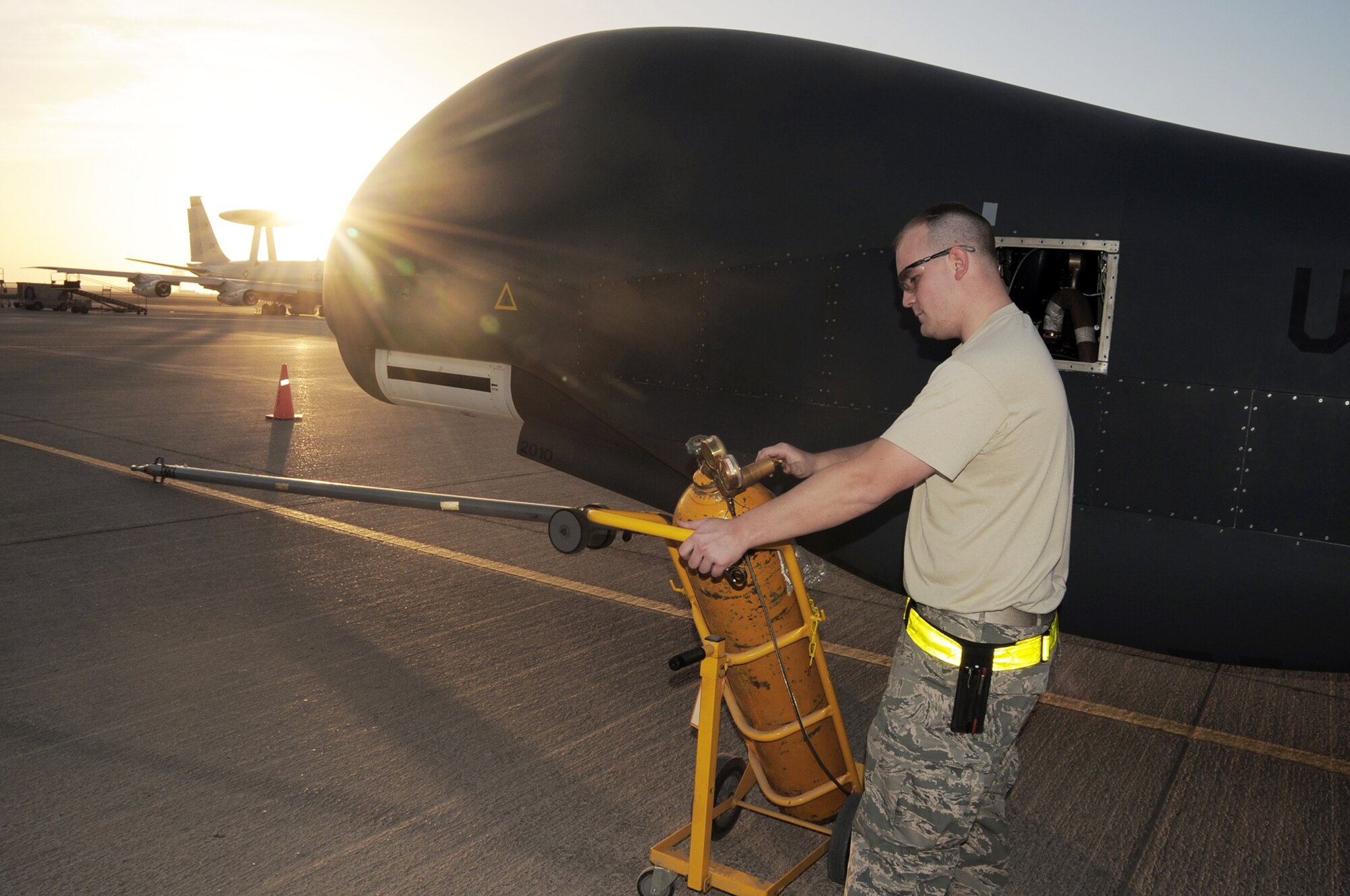 Staff Sgt. Michael Goenner goes through pre-flight servicing while preparing an RQ-4 Global Hawk for a combat mission Feb. 12, 2010, in Southwest Asia. The RQ-4s, assigned to the 380th Air Expeditionary Wing and deployed from Beale Air Force Base, Calif., achieved 1,500 combat sorties and 30,000 combat flying hours on Feb. 10 and 11 respectively. Sergeant Goenner is an RQ-4 Global Hawk crew chief with the 380th Expeditionary Aircraft Maintenance Squadron Hawk aircraft maintenance unit. (U.S. Air Force photo/Master Sgt. Scott T. Sturkol)
