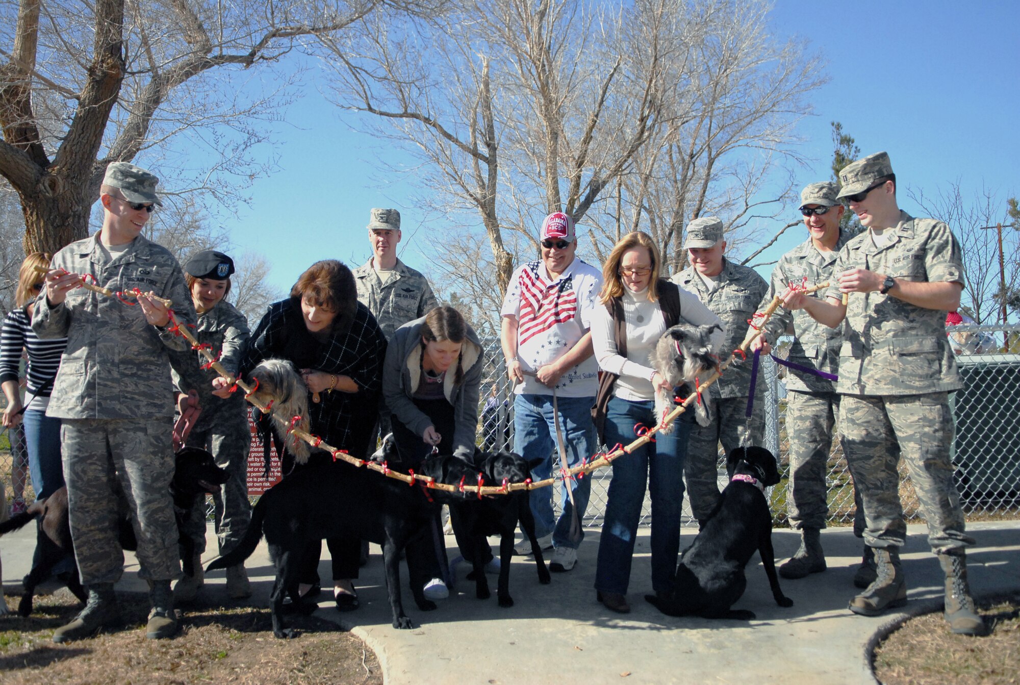 Dogs eat the dog treat ribbon to mark the grand opening of Edwards Bark Park Feb.12. The new park is located on Dessert Villa Circle northwest of the Airmen & Family Readiness Center. (Air Force photo/Airman 1st Class William O'Brien)