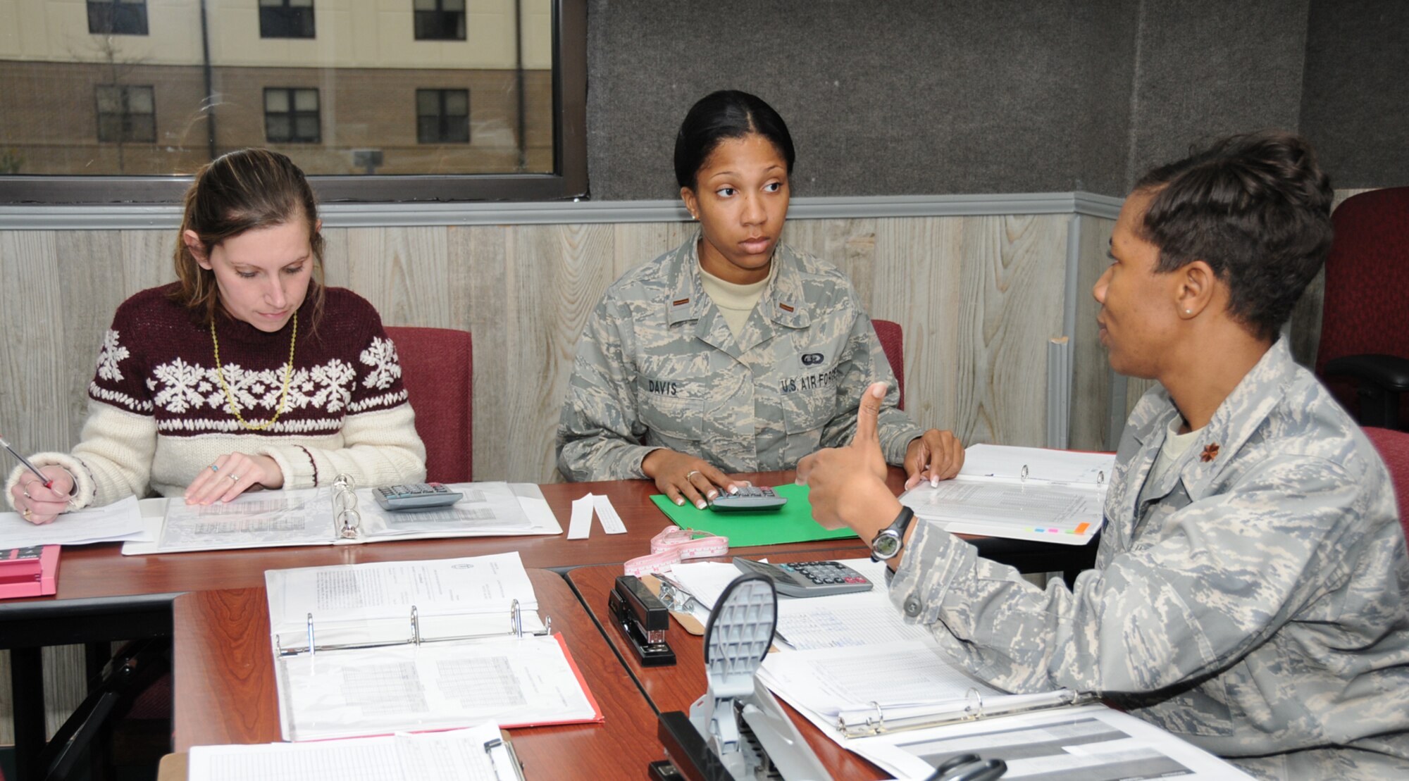 From left, Kristina Brinkmeier, 2nd Lt. DiAundra Davis and Major Yulanda Bogany go over paperwork in the fitness assessment cell office on the second floor of Vanderburg Community Center.  Mrs. Brinkmeier’s husband is Staff Sgt. Erich Brinkmeier, 81st Security Forces Squadron.  (U.S. Air Force photo by Kemberly Groue)