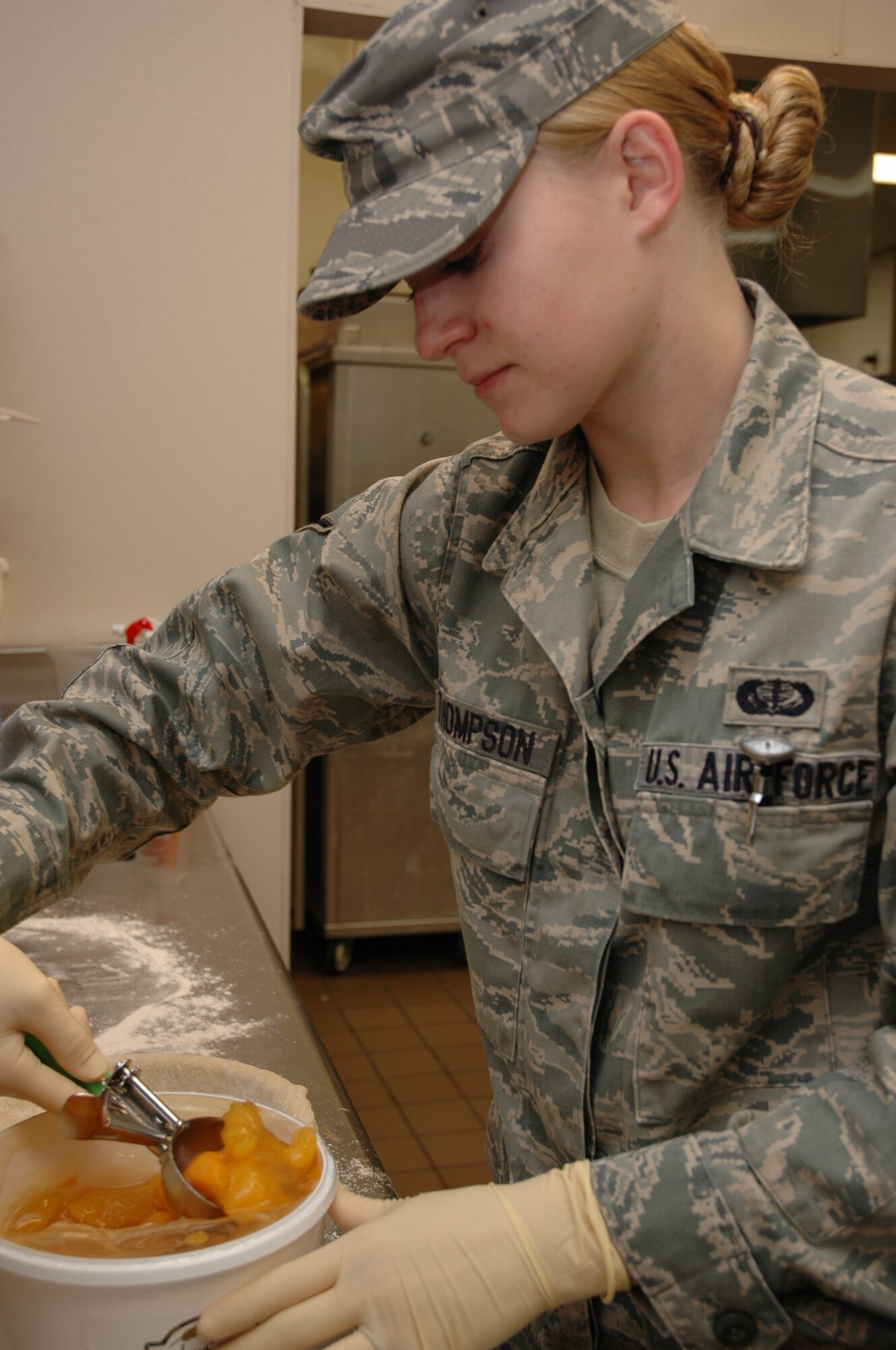 Airman Candace Thompson, 1st Special Operations Force Support Squadron food services specialist, prepares a peach cobbler at the Riptide Dining Facility at Hurlburt Field Feb. 17. The Riptide received an inspection team from the Air Force Hennessy Travelers Association Feb. 15-16 to compete for the title of the best dining facility in the Air Force. (U.S. Air Force photo by Airman Caitlin O'Neil.)
