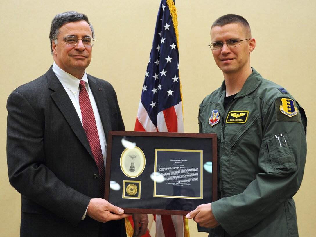 ELLSWORTH AIR FORCE BASE, S.D.-- Capt. Louis "Salami" Heidema, 37th Bomb Squadron weapons systems officer and BONE 23 crew member, accepts the 2008 Mackay Trophy from Jonathan Gaffney, president and CEO of the National Aeronautic Association, the oldest national aviation organization in the United States, Feb 16. The Mackay Trophy is the oldest and most prestigious award given annually to Air Force aircrews for the most meritorious flight of the year.  BONE 23 received the award for outstanding performance in a deployed environment. Previous recipients have included Gen. Henry “Hap” Arnold, Capt. Eddie Rickenbacker, Major Gen. Chuck Yeager, and former 34th Bomb Squadron Raider General Jimmy Doolittle.  (U.S. Air Force photo/Master Sgt. Loren J. Bonser)