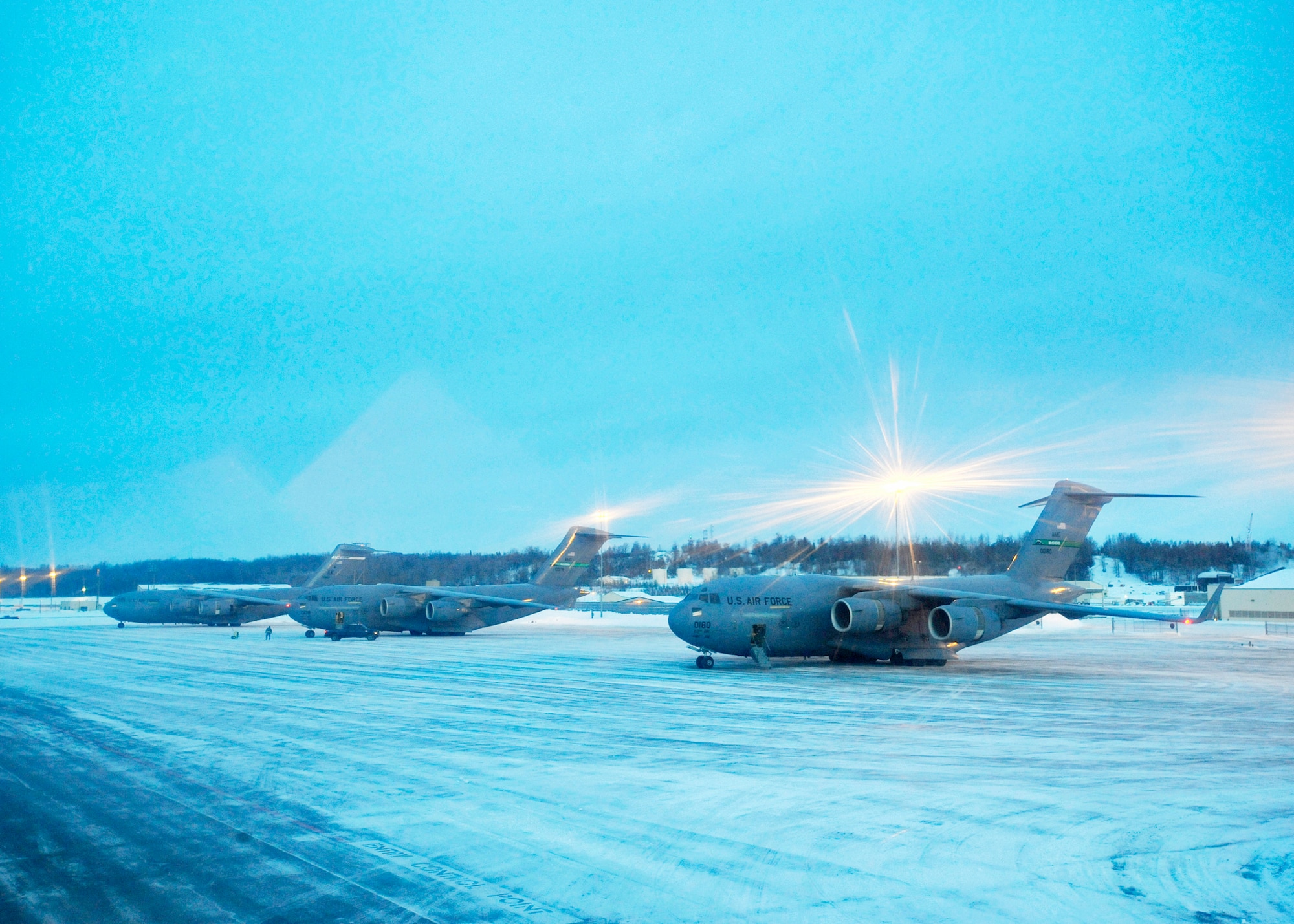 C-17 Globemaster IIIs sit on the ramp at Elmendorf Air Force Base, Alaska, waiting to take off Feb. 10, 2010. The aircraft assigned to Pacific Air Forces and Air Mobility Command were participating in an exercise that involved exploring capabilities in large formations and improving tactical awareness among aircrews. (U.S. Air Force photo/Senior Airman Matt Coleman-Foster)