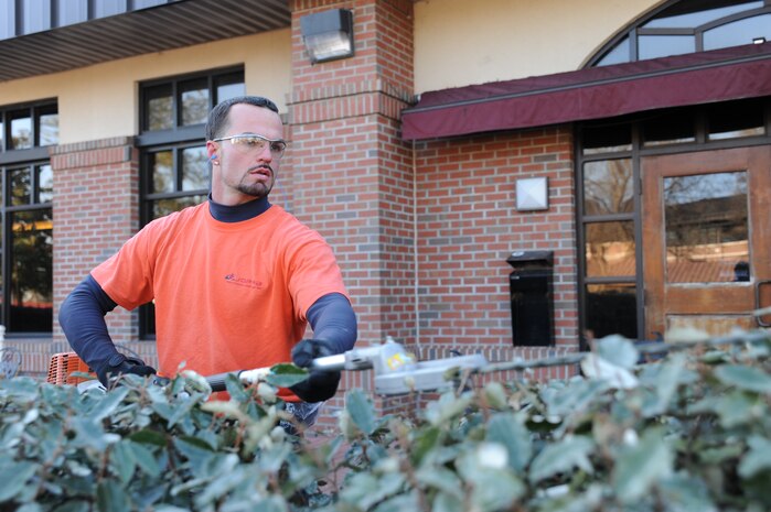Matthew Cancellare trims a bush on Joint Base Charleston Feb. 17. Mr. Cancellare is a member of the landscaping crew that works for Joppa Maintenance Company. Joppa is a ground maintenance company which performs landscaping services for military installations. (U.S. Air Force photo/Senior Airman Katie Gieratz)(RELEASED)
