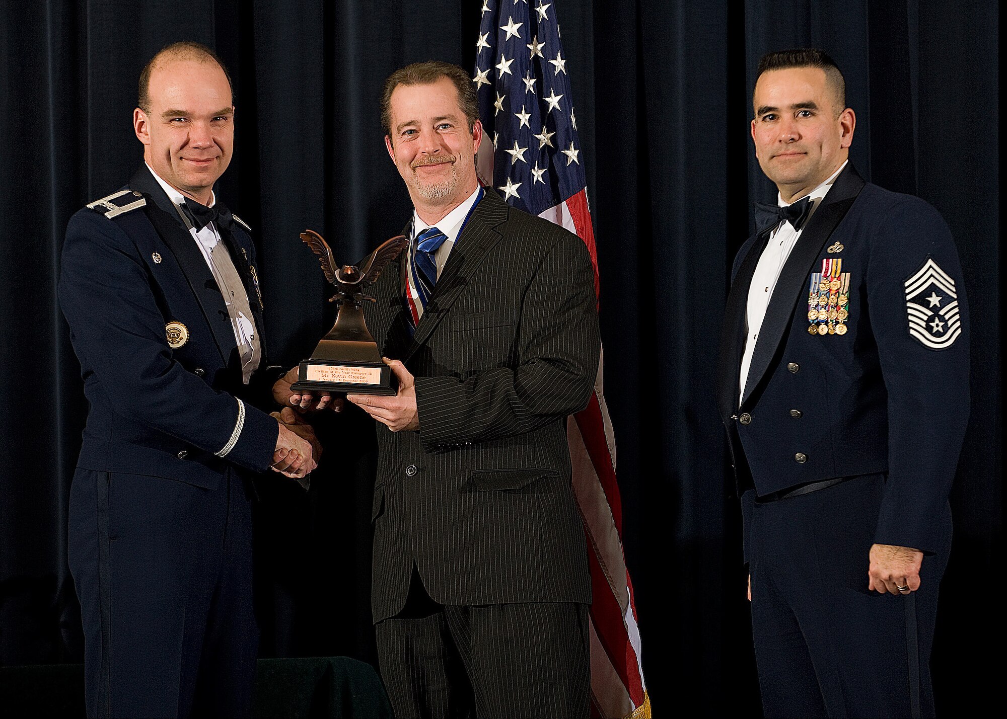 (Left) Col. Manson Morris, 436th Airlift Wing commander, and Chief Master Sgt. John Evalle, 436th AW command chief, present Kevin Greene, 436th AW Safety, with the award for Category II Civilian of the Year during the Annual Awards ceremony Feb. 12. (U.S. Air Force photo/Roland Balik)