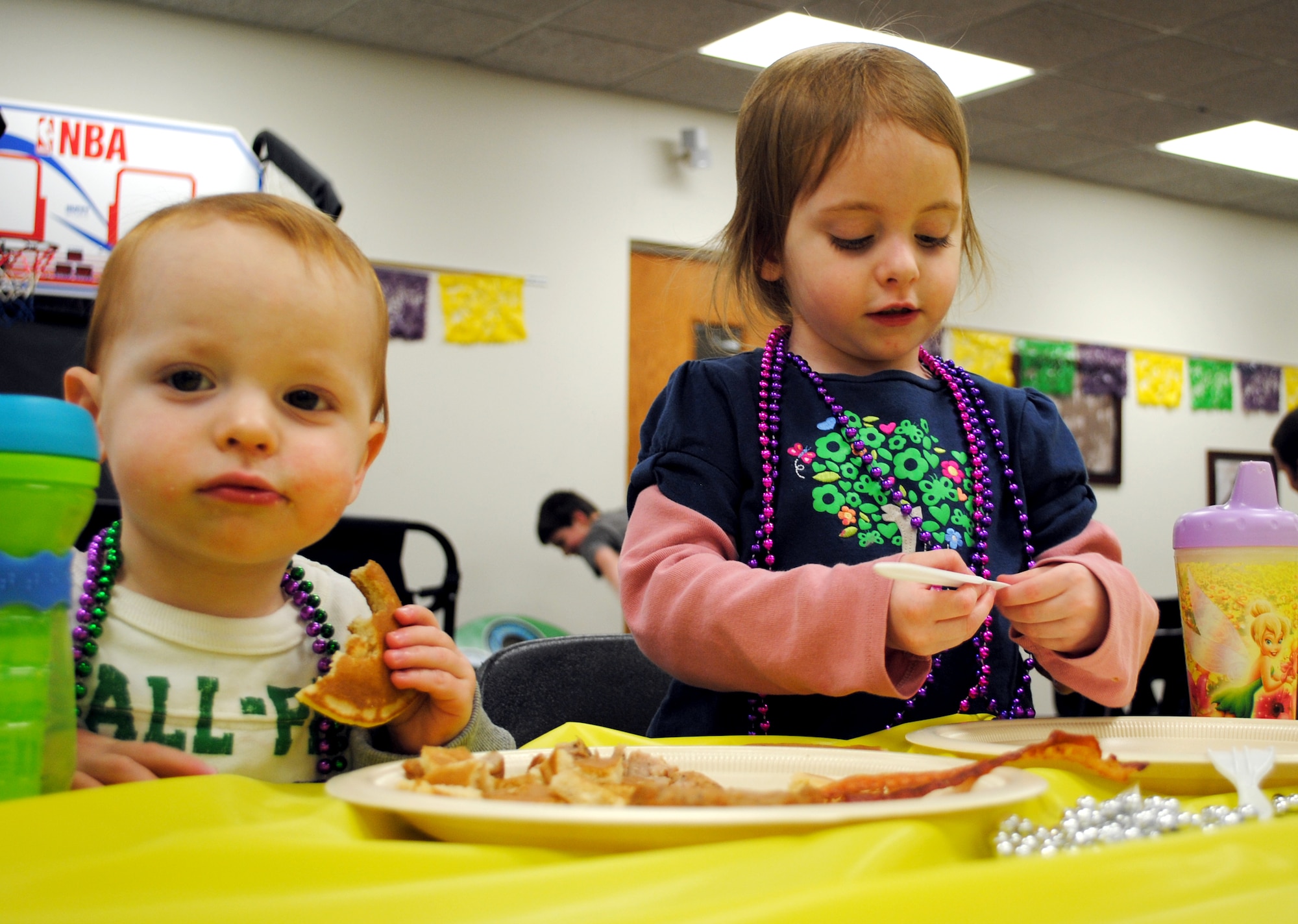 Matthew, 2, and his sister, Kendall, 3, two of the youngest Team Vance members attending the Shrove Tuesday pancake supper, enjoy the food prepared by the Vance AFB Chapel staff. More than 100 attended the event in the Community Chapel Activity Center Feb. 16. In addition to pancakes, waffles and the fixings, carnival games and a bouncy house were available for the families. Shrove Tuesday, like Mardi Gras, is a final feast before the beginning of the Lent Season. The Chapel will host Lent luncheons every Wednesday at noon, March 10 through 31. (U.S. Air Force photo/ 1st Lt. Agneta Murnan)