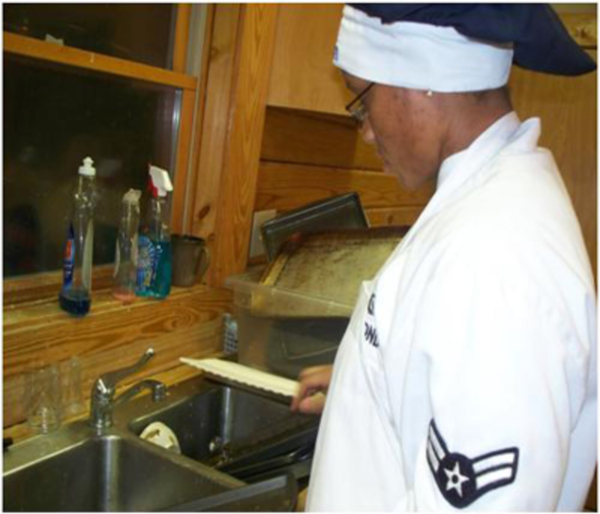 SHAW AIR FORCE BASE, S.C. -- Airman 1st Class Denasha Monday cleans utensils in preparation for Wateree Recreation Area's Valentine Murder Mystery dinner Feb. 13.  (Courtesy photo/Mary Marshall)