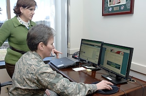 Barbara Lang, back, assists Col. Martha Meeker with her pledge to save money as Military Saves Week prepares to kick off at Joint Base Charleston, S.C., Feb. 17, 2010. Feb. 19 marks the beginning of a week-long national campaign to persuade, motivate and encourage military families to save money every month and to convince leaders and organizations to be aggressive in promoting automatic savings. Military Saves encourages the military community to meet immediate needs and build long-term wealth through saving and debt reduction. Colonel Meeker is the 628th Air Base Wing commander and Ms. Lang is the project officer for this year's Military Saves campaign. (U.S. Air Force photo/Staff Sgt. Marie Brown)