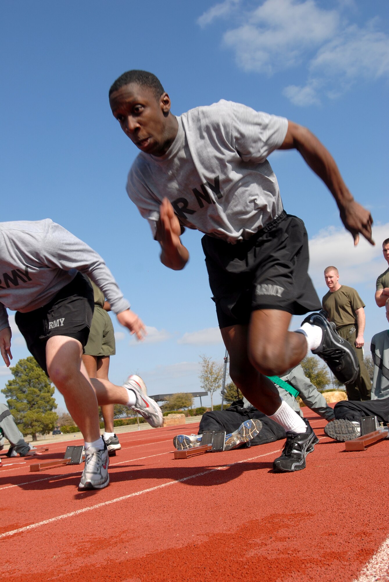 Private Chris Green, 344th Military Intelligence Battalion, leaves the starting block at the start of a 100 yard dash heat during the 17th Training Wing Sports Day on Feb. 12. Goodfellow AFB, Texas took the day to hold multiple sporting events, including volleyball, tennis, and dodge ball, with each unit competing for commander’s cup points.  (U.S. Air Force photo/Master Sgt. Randy Mallard)

