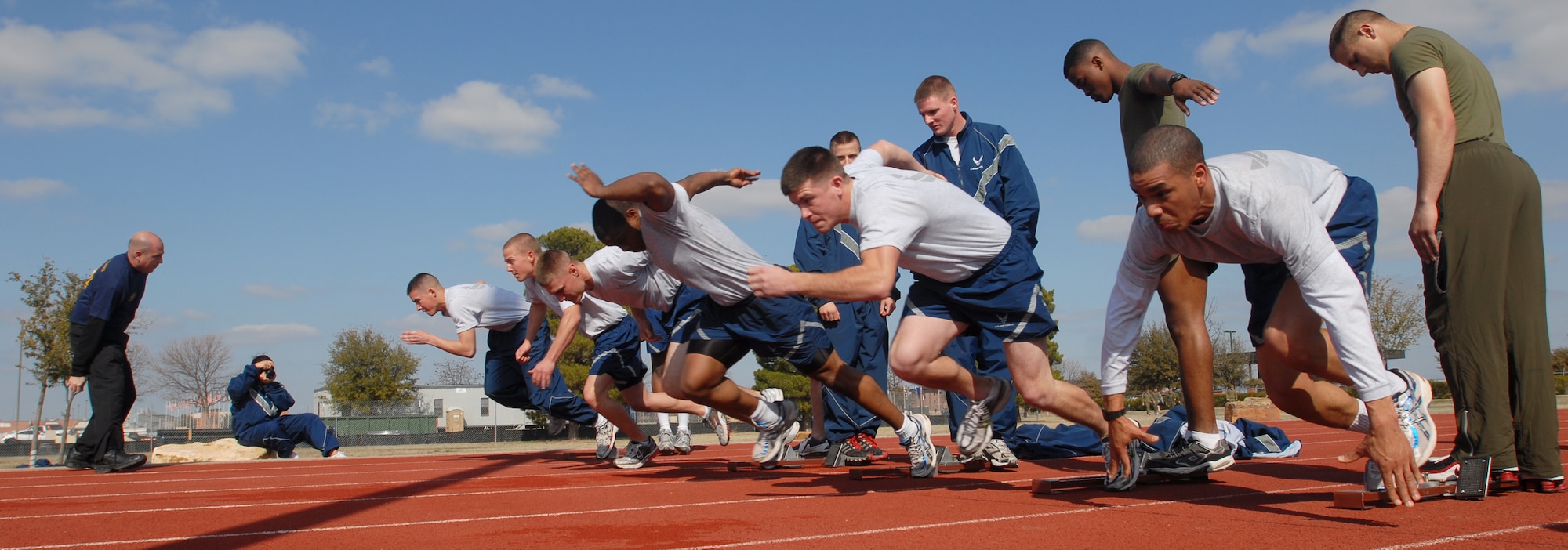 Airmen push off from the start line for one of the 100 yard dash heats during the 17th Training Wing Sports Day on Feb. 12. Goodfellow AFB, Texas took the day to hold multiple sporting events, including volleyball, tennis, and dodge ball, with each unit competing for commander’s cup points.  (U.S. Air Force photo/Master Sgt. Randy Mallard)